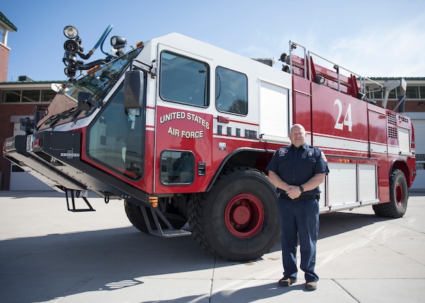 Firefighter Russell Pressley, a driver/operator with the Roland R. Wright Fire Department stands beside a Oshkosk “Striker” Fire Fighting truck March 11, 2019 at Roland R. Wright Air National Guard Base, Salt Lake City, Utah. Pressley responded to a tanker truck fire in Salt Lake City on February 22, 2019 and was able to assist local fire fighters with the specialized truck.