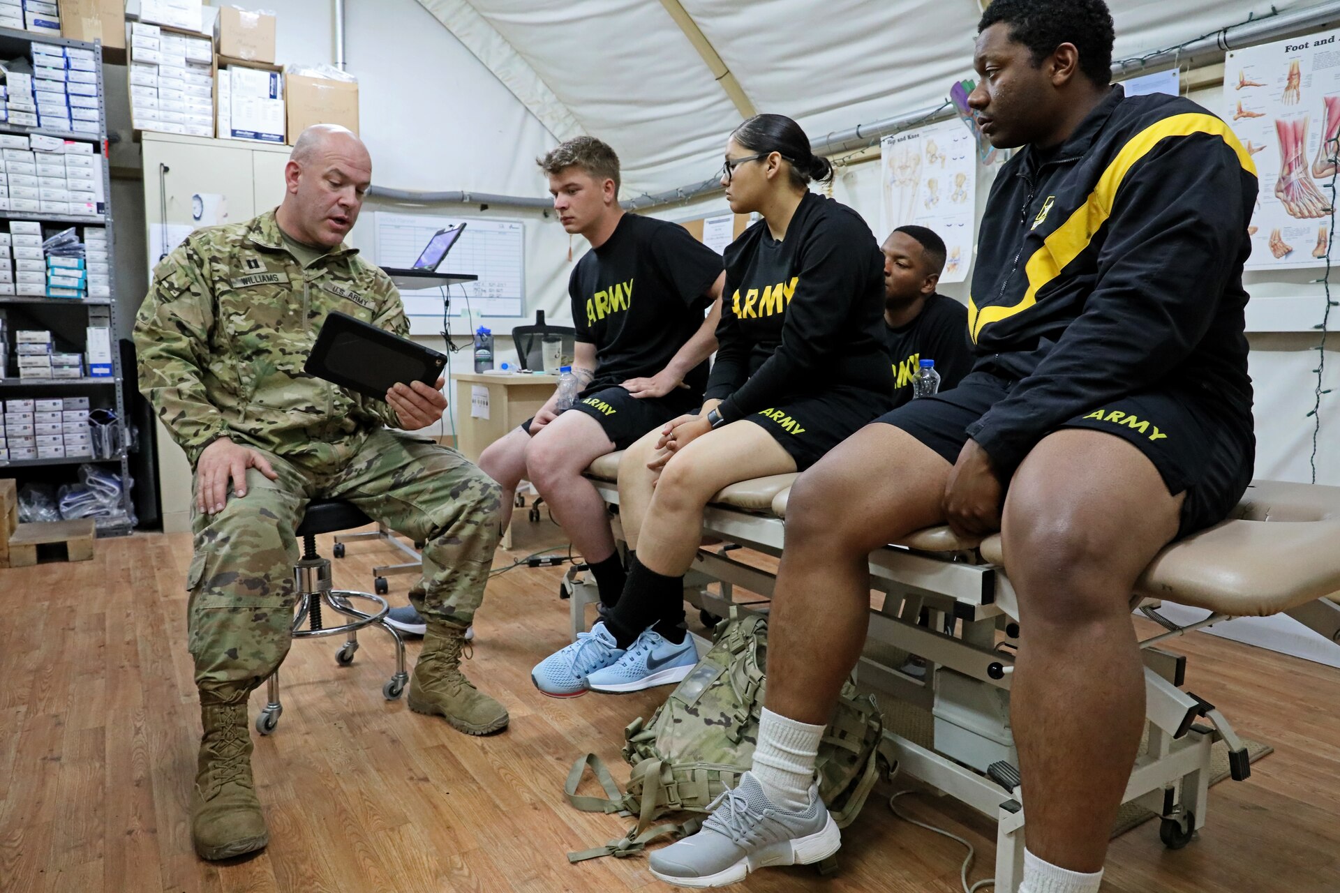 Cpt. Anthony Williams, physical therapist for 3rd Armored Brigade Combat Team, 4th Infantry Division, shows Soldiers video of their running gait in order to correct deficiencies and prevent injury, as part of a weekly running class at Camp Buehring, Kuwait. Williams evaluated the running form of each Soldier and provided feedback for how to improve form and mechanics.