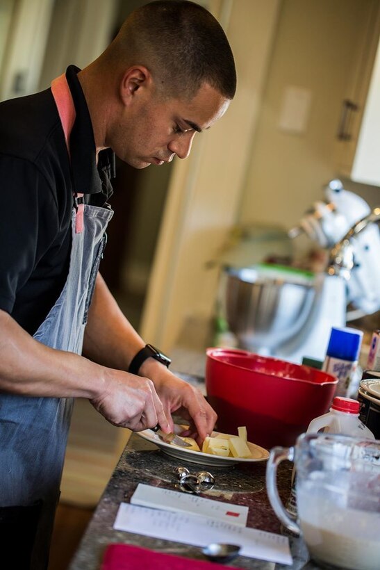 Staff Sgt. Brandle prepares dinner for the depot commanding general and his guests Jan. 10, 2019. Cooking is one of the many responsibilities he has as the enlisted aide. (U.S. Marine Corps photo by Lance Cpl. Carlin Warren)