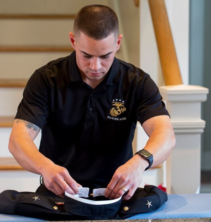 Staff Sgt. Christopher Brandle, the enlisted aide for Marine Corps Recruit Depot Parris Island, prepares Brig. Gen. James Glynn's uniforms Jan. 15, 2019. Brandle, a 29-year old from Fresno, Calif., is responsible for the cleanliness and maintenance of the general's house, his uniform and cooking for daily meals and events. (U.S. Marine Corps photo by Lance Cpl. Carlin Warren)