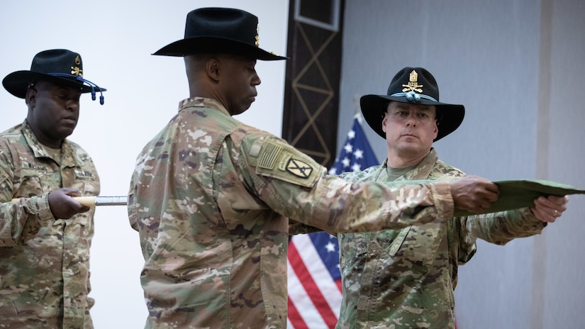 U.S. Army Lt. Col. Omar T. Minott, the New Jersey National Guard’s 1st Squadron, 102nd Cavalry Regiment (1-102 CAV) commander and Command Sgt. Maj Eric Maney, command sergeant major for the 1-102 CAV, unfurl their unit colors during a transfer of authority ceremony at the Joint Training Center in Jordan, March 14, 2019. The 1-102 CAV took over mission authority from the California National Guard’s 1st Squadron, 18th Cavalry Regiment and will work as part of the Jordan Operational Engagement Program mission.