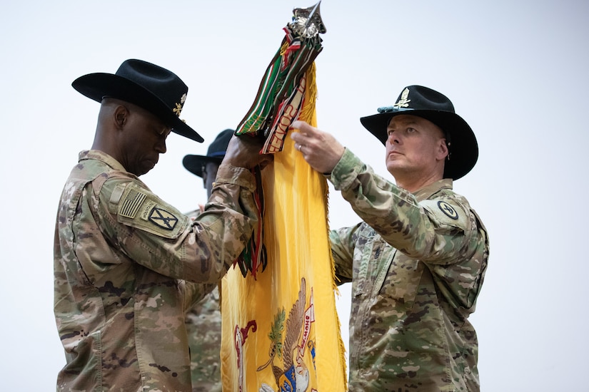 U.S. Army Lt. Col. Omar T. Minott, the New Jersey National Guard’s 1st Squadron, 102nd Cavalry Regiment (1-102 CAV) commander and Command Sgt. Maj. Eric Maney, command sergeant major for the 1-102 CAV, unfurl their unit colors during a transfer of authority ceremony at the Joint Training Center in Jordan, March 14, 2019. The 1-102 CAV assumed mission authority from the California National Guard’s 1st Squadron, 18th Cavalry Regiment and will work closely with the Jordan Armed Forces as part of Jordan Operational Engagement Program.
