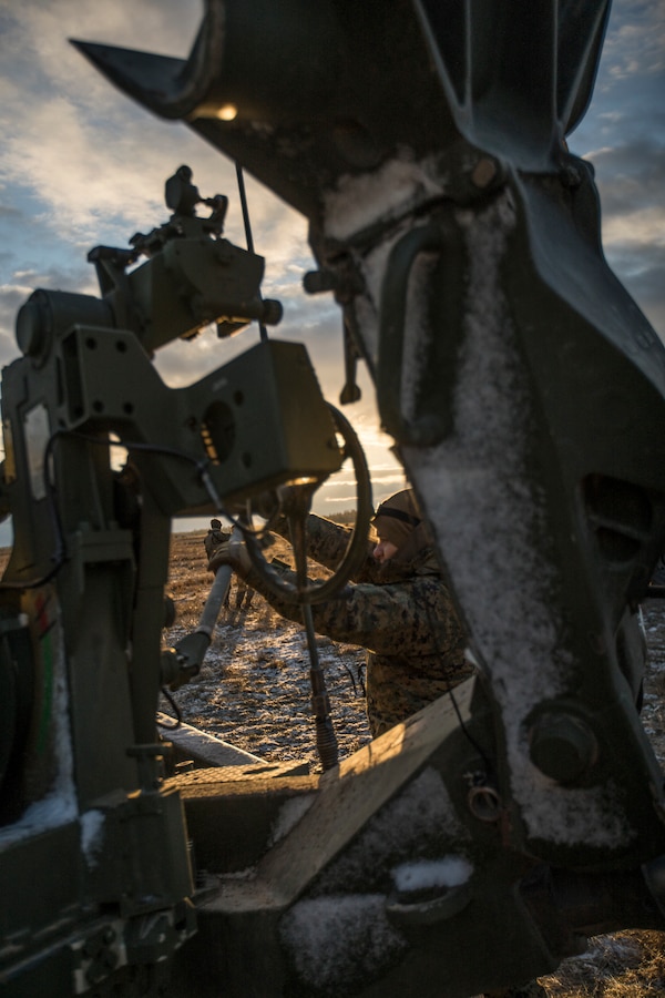 A U.S. Marine with Hotel Battery, 3rd Battalion, 14th Marine Regiment, 4th Marine Division, adjusts a M777 howitzer before a live-fire range at Adazi Training Area, Latvia, March 1, 2019, during exercise Dynamic Front 19. Approximately 3,200 participants from 27 nations will take part in the live-fire portion of exercise Dynamic Front 19, March 2-9, 2019, at the U.S. Army's Grafenwoehr Training Area, Germany; as well as in Riga, Latvia; and Torun, Poland. (U.S. Marine Corps photo by Cpl. Niles Lee)