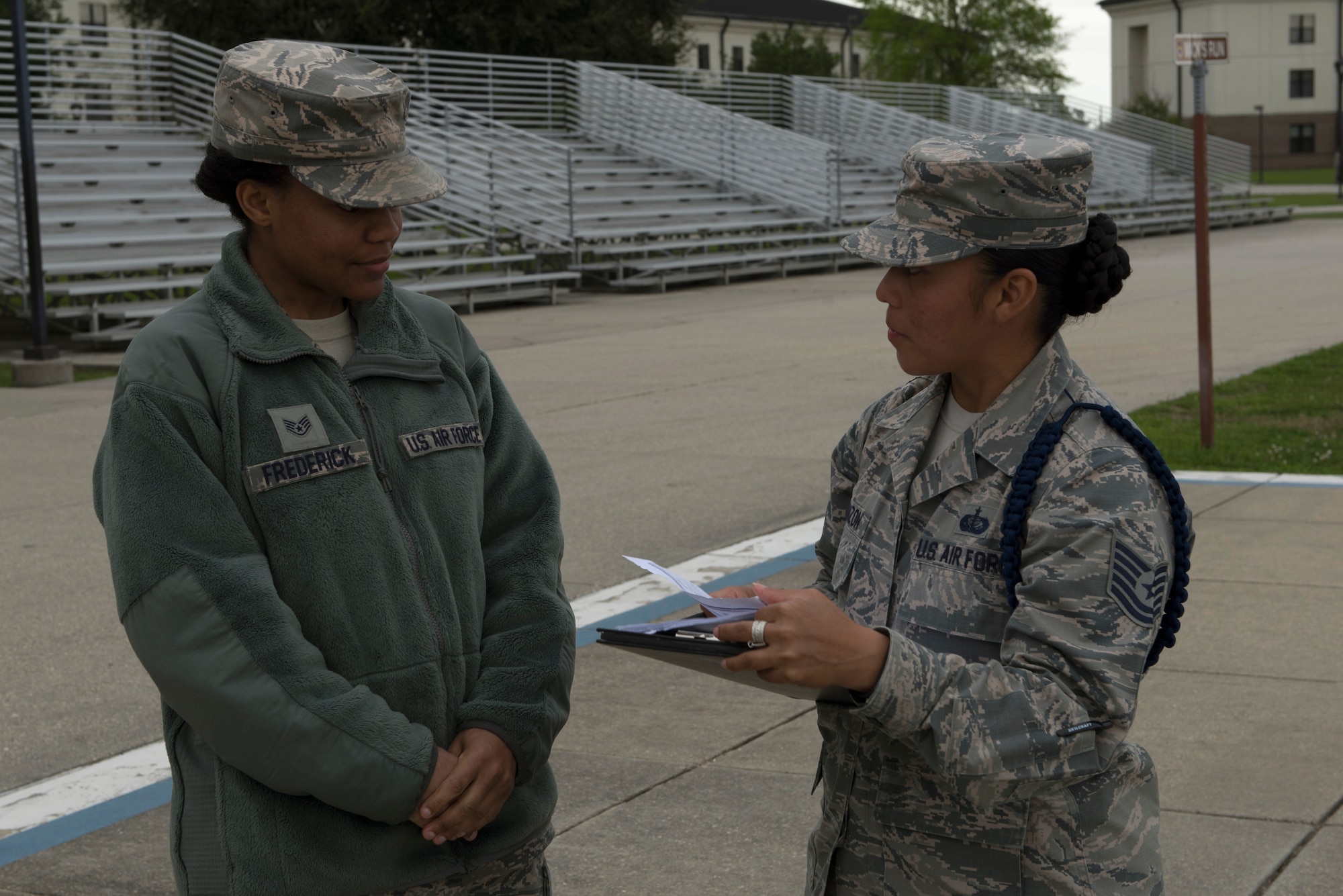 U.S. Air Force Staff Sgt. Ebone Frederick, 81st Training Support Squadron military training leader student, receives advice in performing an open-ranks inspection from Tech. Sgt. Victoria Monzon, 81st TRSS MTL instructor, at Keesler Air Force Base, Mississippi, March 15, 2019. The evaluation allowed Monzon to assist her student in performing a higher quality open-ranks inspection and strengthen the student’s skill-set as a future MTL. (U.S. Air Force photo by Airman 1st Class Kimberly Mueller)