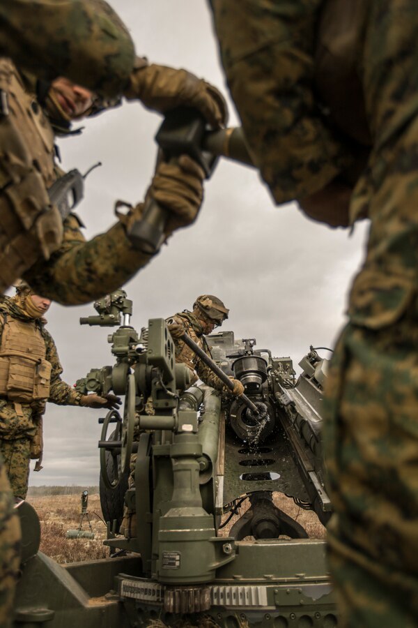 U.S. Marines with Hotel Battery, 3rd Battalion, 14th Marine Regiment, 4th Marine Division, prepare a M777 howitzer and 155 mm round during a live-fire range at Adazi Training Area, Latvia, March 2, 2019, during exercise Dynamic Front 19. Approximately 3,200 participants from 27 nations will take part in the live-fire portion of exercise Dynamic Front 19, March 2-9, 2019, at the U.S. Army's Grafenwoehr Training Area, Germany; as well as in Riga, Latvia; and Torun, Poland. (U.S. Marine Corps photo by Cpl. Niles Lee)