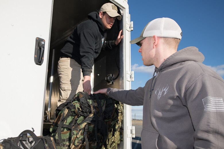 Staff Sgt. Brandon Soto, 436th Security Forces Squadron military working dog handler, hands out rucksacks to the participants of the 20th Annual Chosin Ruck March on March 16, 2019, at the Air Mobility Command Museum on Dover Air Force Base, Del. Participants ran or walked the course carrying rucksacks varying in weight. (U.S. Air Force Photo by Mauricio Campino)
