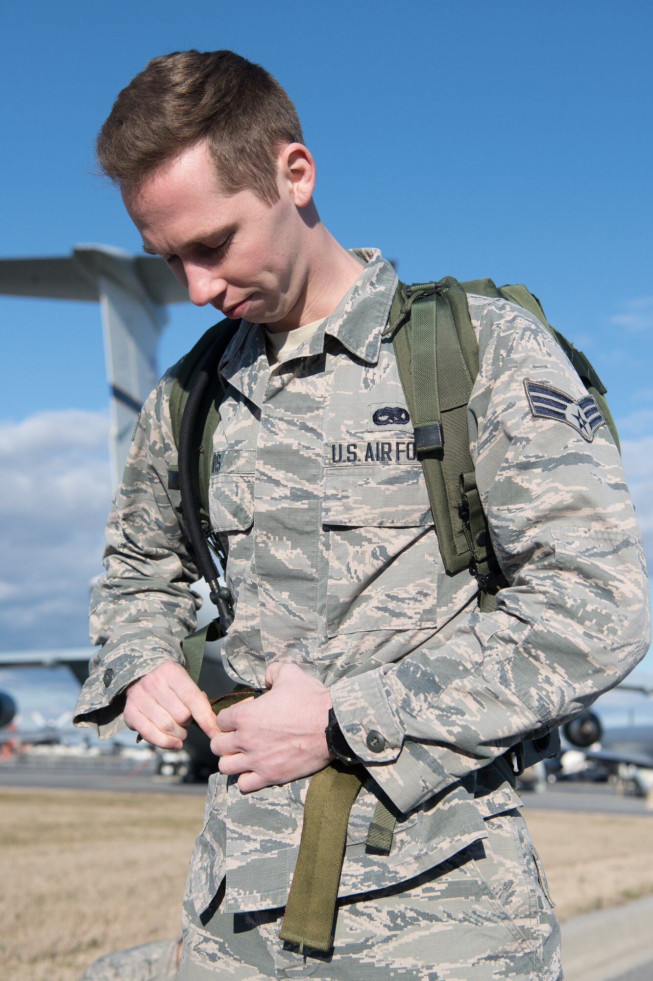 Staff Sgt. Brandon Soto, 436th Security Forces Squadron military working dog handler, hands out rucksacks to the participants of the 20th Annual Chosin Ruck March on March 16, 2019, at the Air Mobility Command Museum on Dover Air Force Base, Del. Participants ran or walked the course carrying rucksacks varying in weight. (U.S. Air Force Photo by Mauricio Campino)