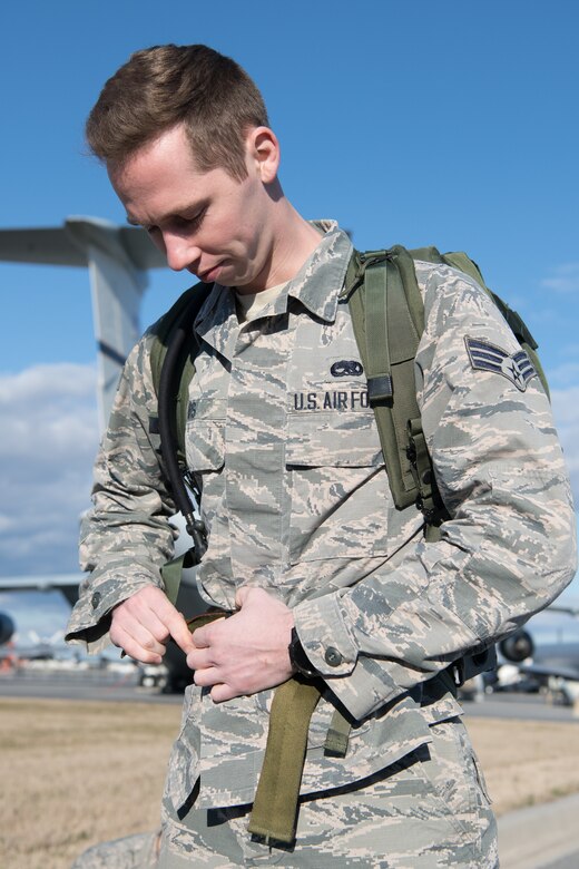 Staff Sgt. Brandon Soto, 436th Security Forces Squadron military working dog handler, hands out rucksacks to the participants of the 20th Annual Chosin Ruck March on March 16, 2019, at the Air Mobility Command Museum on Dover Air Force Base, Del. Participants ran or walked the course carrying rucksacks varying in weight. (U.S. Air Force Photo by Mauricio Campino)