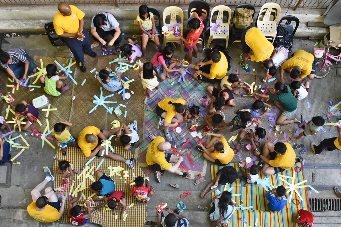 An aerial view of a group of adults and children doing arts and crafts.