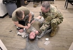Wyoming Army National Guard Sgt. Shawn Todd, a combat medic assigned to Recruiting and Retention Battalion and Sgt. 1st Class Ethan Schanzenbach, 213th Regional Training Institute senior medical noncommissioned officer, treat a neck wound on mock patient, Spc. Tailor Johnson, a combat medic assigned to the 115th Field Artillery Brigade, during 68W annual sustainment training at the 213th RTI in Guernsey March 6, 2019.