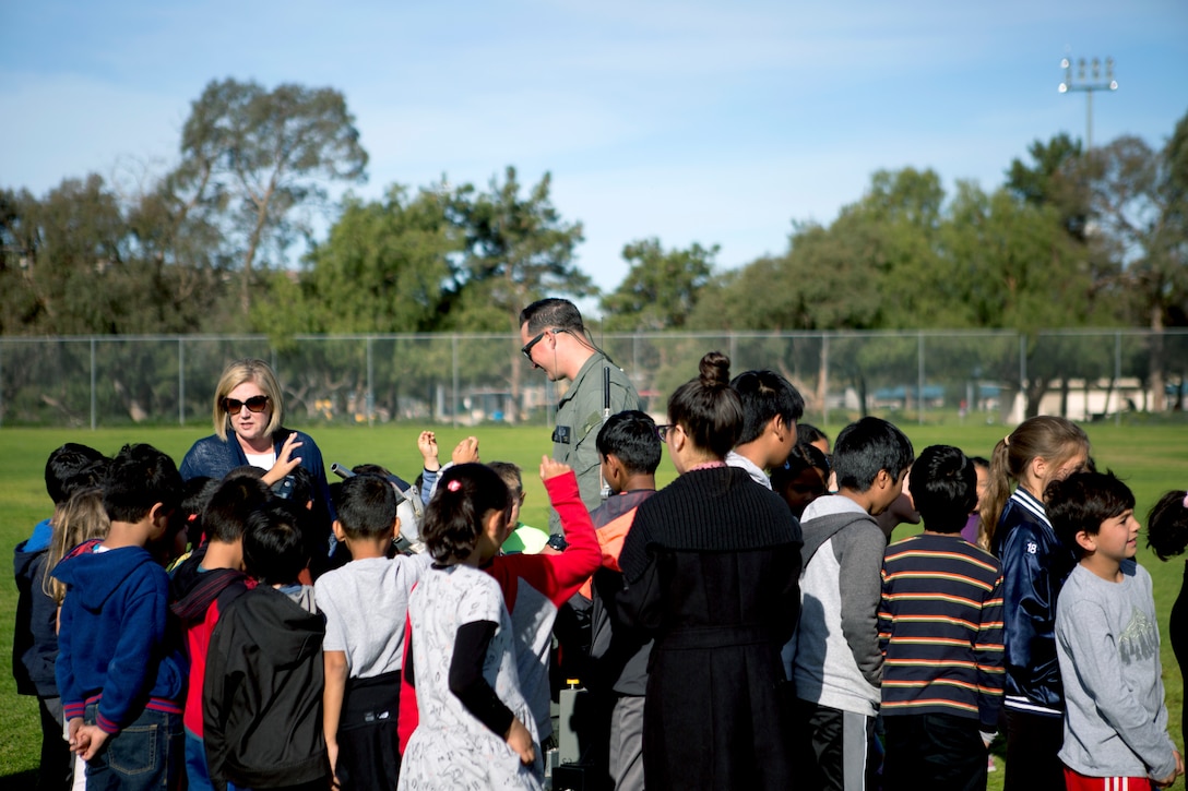 Dingeman Elementary students interact with Staff Sgt. Thomas J. Faenza, an Explosive Ordnance Disposal (EOD) Technician with Headquarters and Headquarters Squadron, during an EOD demonstration at Dingeman Elementary School in San Diego, Calif., Mar. 15. The Marines conducted this demonstration to teach students about robotics as well as form stronger relations with the surrounding community. (U.S. Marine Corps photo by Lance Cpl. Cheng Chang)