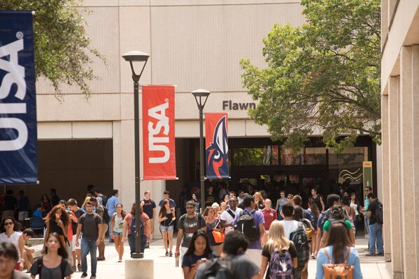 Students walking around the UTSA campus on a sunny school day.