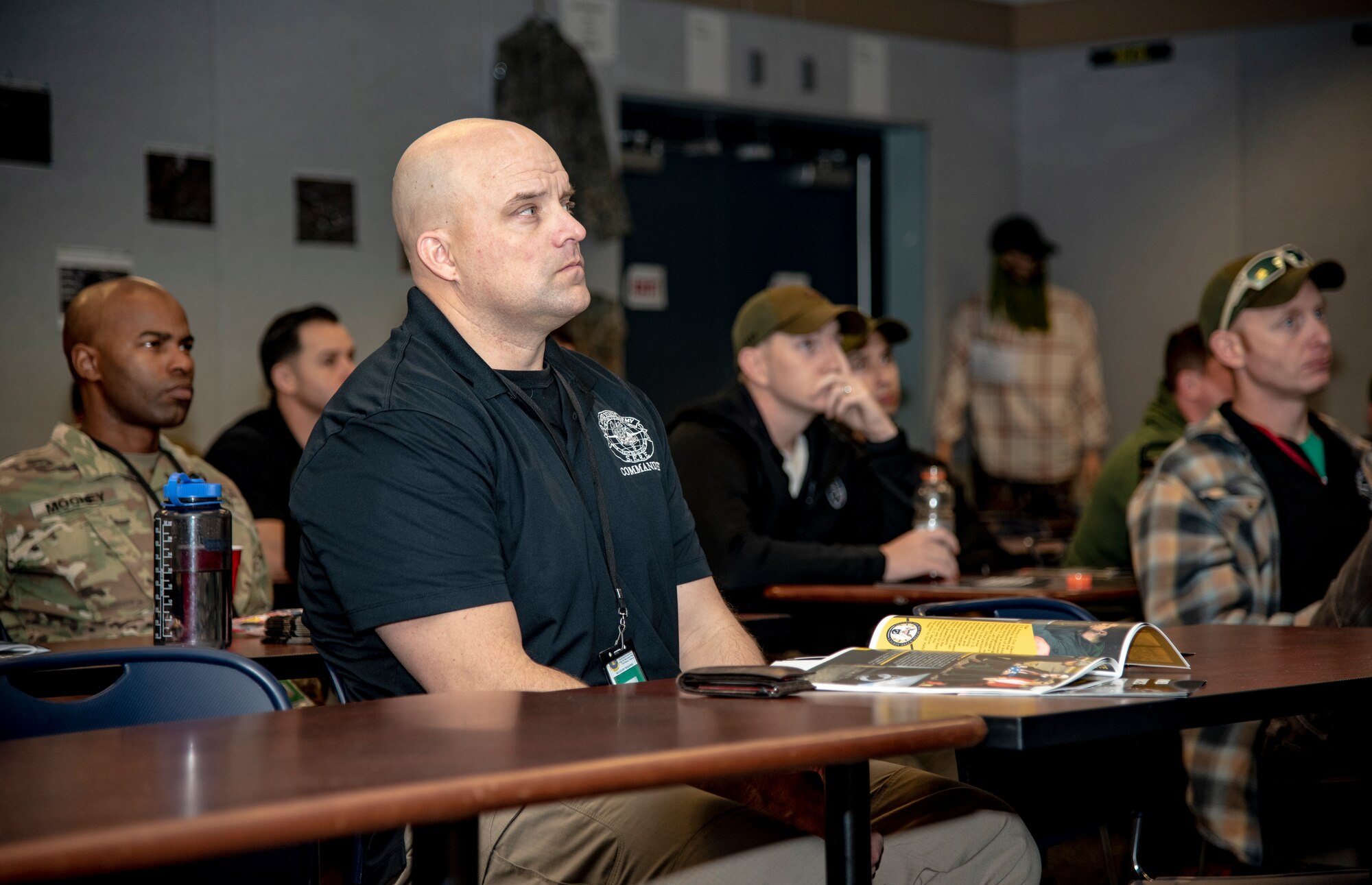 U.S. Army MAJ Glenn Anderson, U.S. Army Survival, Evasion, Resistance and Escape school detachment commander, and S.E.R.E instructors listen to briefings from Defense POW/MIA Accounting Agency and Armed Forces Medical Examiner System representatives at Fort Rucker, Alabama, January 25, 2019. The DPAA and AFMES provided local outreach to communities in Alabama to educate on their respective missions. (U.S. Air Force photo by Staff Sgt. Nicole Leidholm)