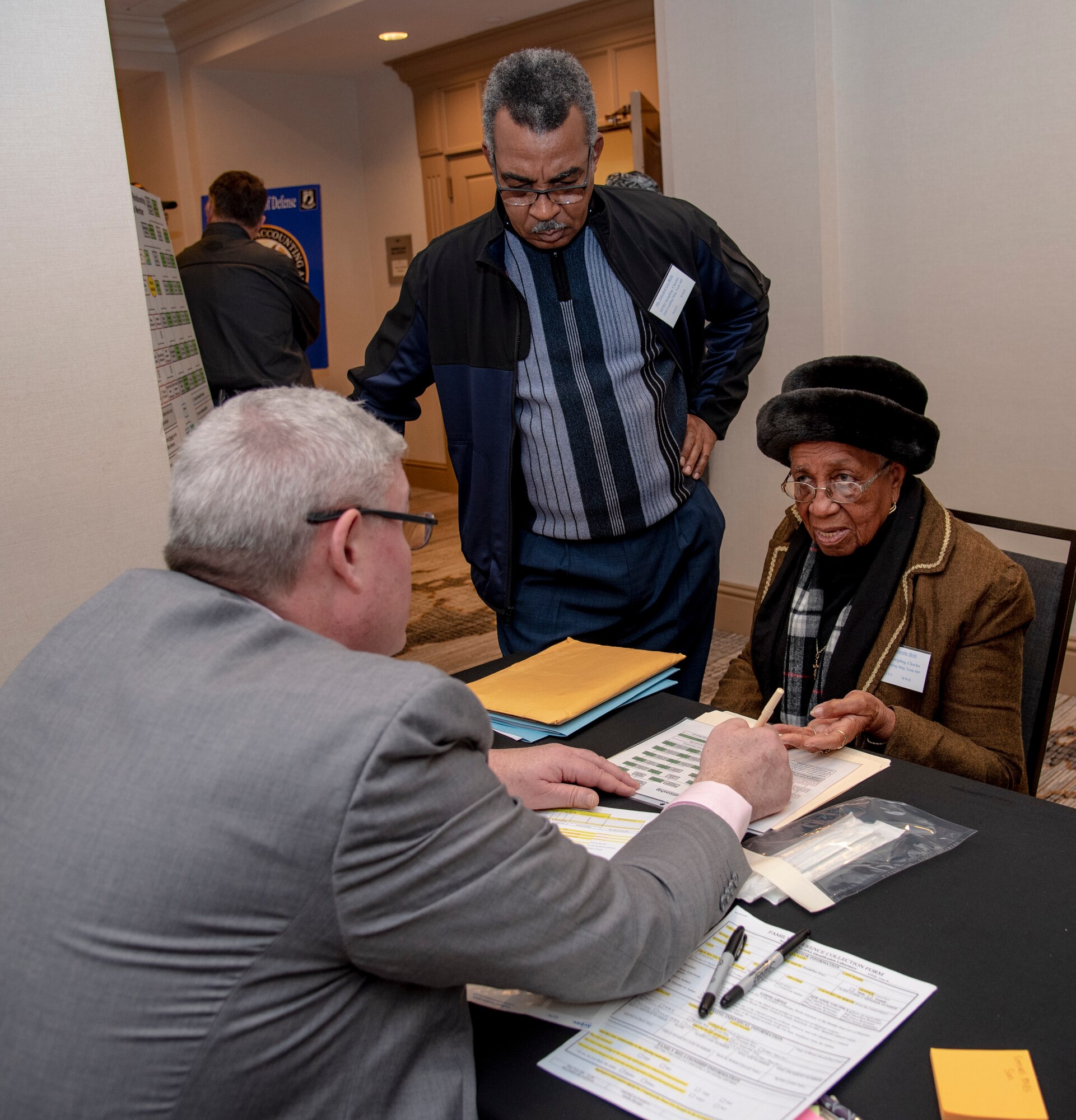 Dr. Tim McMahon (left), Armed Forces Medical Examiner System Department of Defense DNA Operations director, talks with Dorothy Britt, about family reference sample to see if she is eligible to donate DNA during a family member update in Birmingham, Alabama, January 26, 2019. The Defense POW/MIA Accounting Agency conducts periodic and annual government briefings for families of service members who are missing in action. These events are designed to keep family members informed of those still missing and to discuss in detail the latest information available about their specific case. (U.S. Air Force photo by Staff Sgt. Nicole Leidholm)