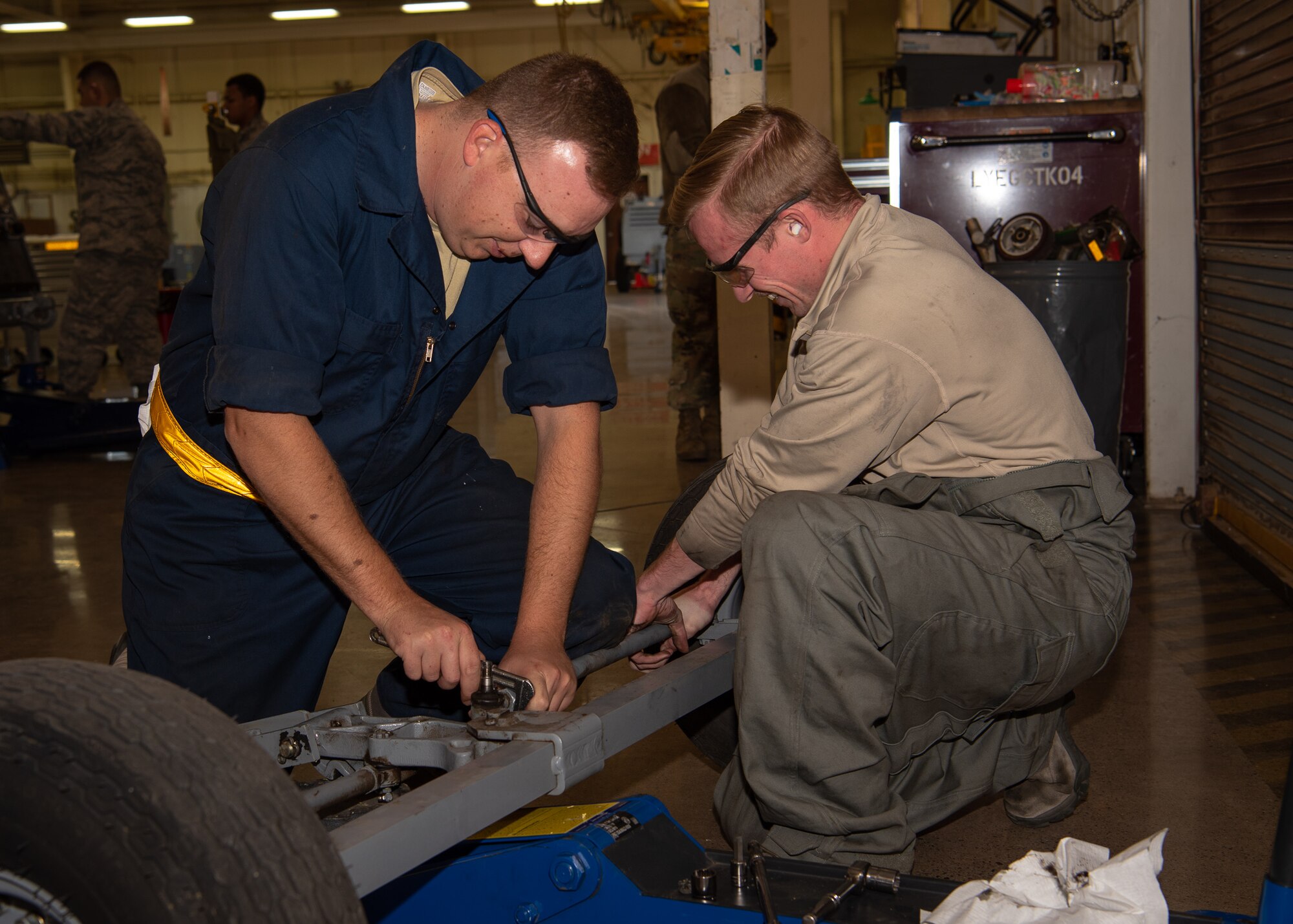 Staff Sgt. Brad Davis and Airman 1st Class Connor Blankenship 56th Equipment Maintenance Squadron Aerospace Ground Equipment maintainers replace a part on an axel, March 14, 2019, at Luke Air Force Base, Ariz.