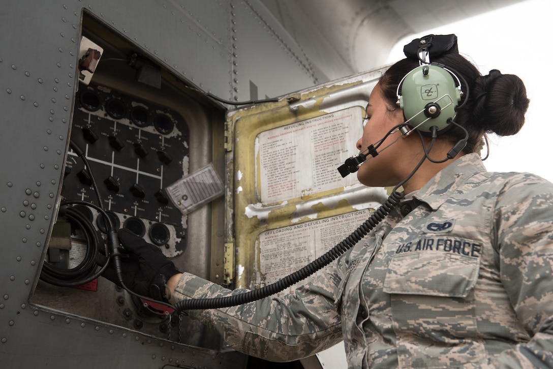 Airman checking aircraft fuel gauges.