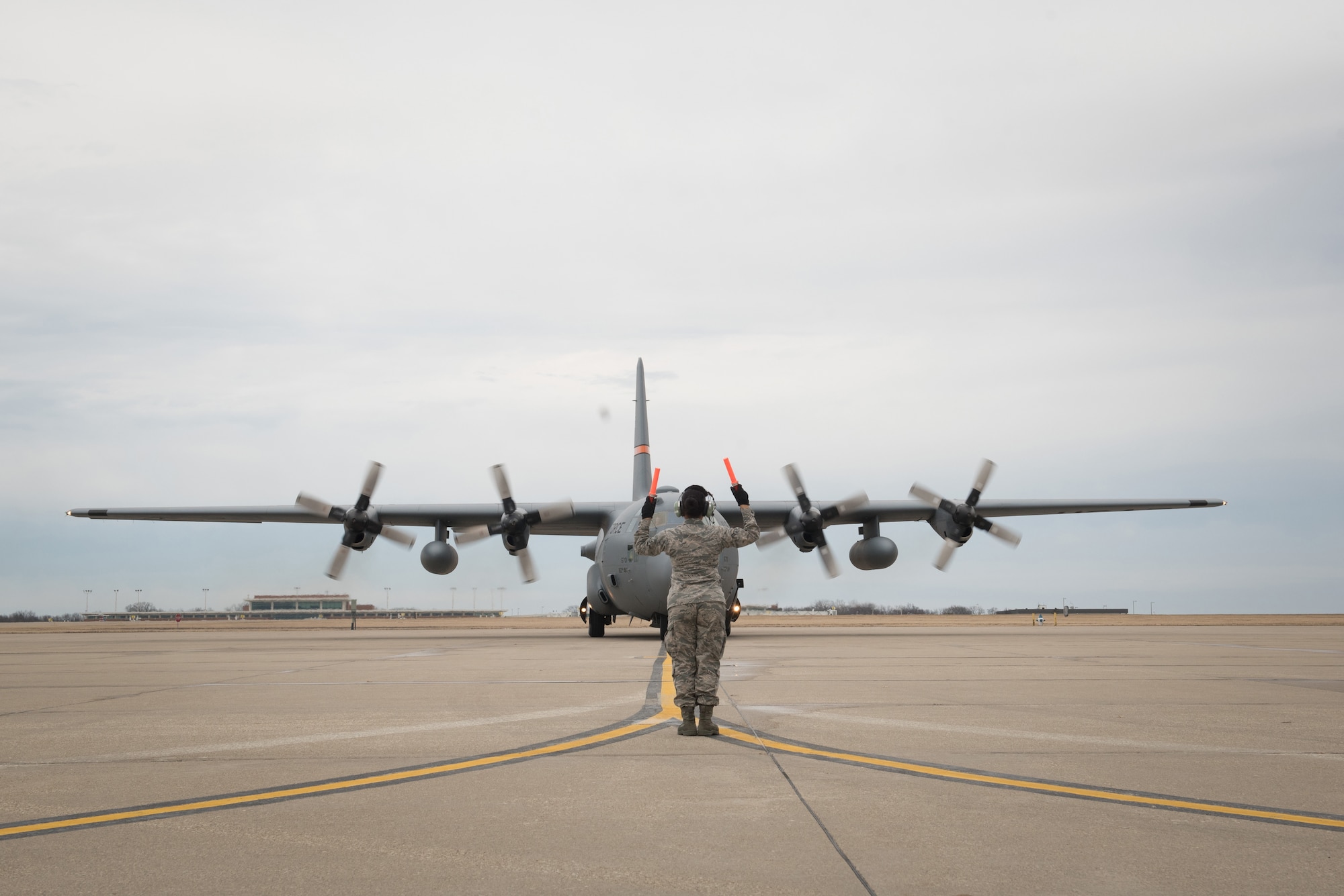 Airman marshalling aircraft.