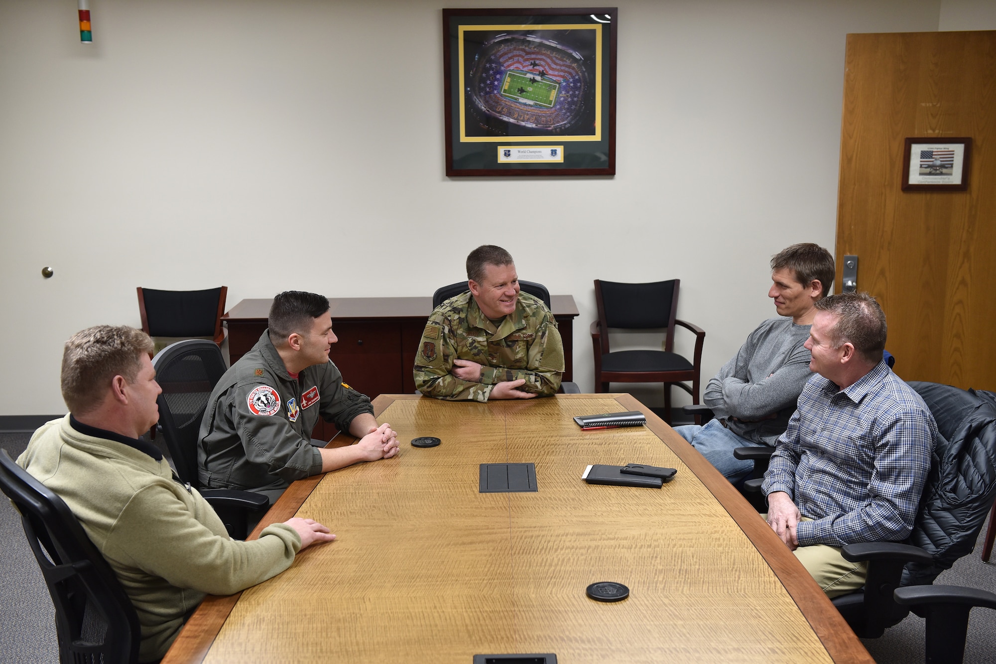 115th Fighter Wing Vice Commander Col. Christopher Green, center, joins members of the wing's safety team during a meeting with safety specialists from Midwest energy company Alliant Energy at Truax Field, Wisconsin, Mar. 7, 2019.