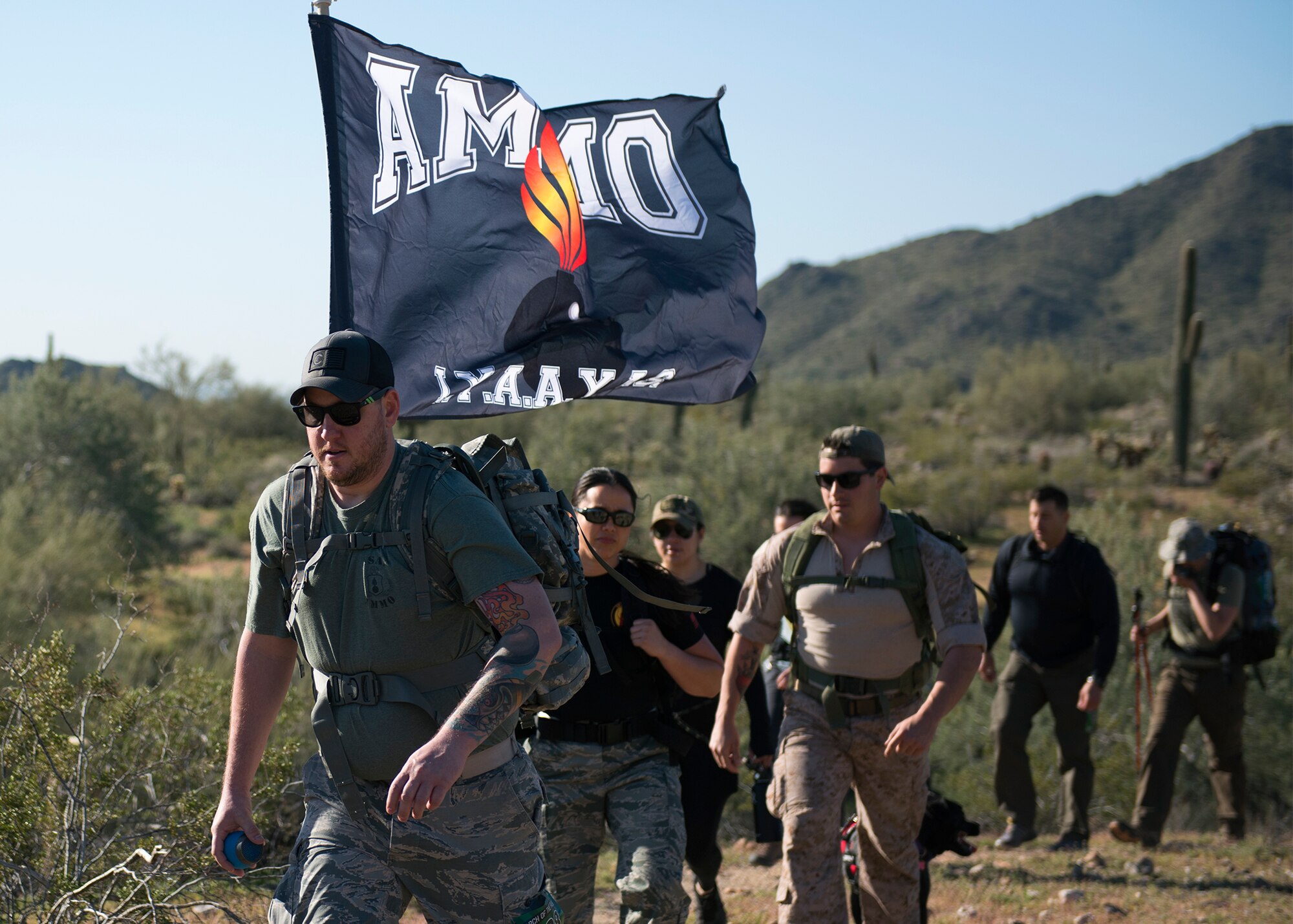 Participants in the March of the Fallen ruck march climb a hill in Buckeye, Ariz., March 16, 2019.