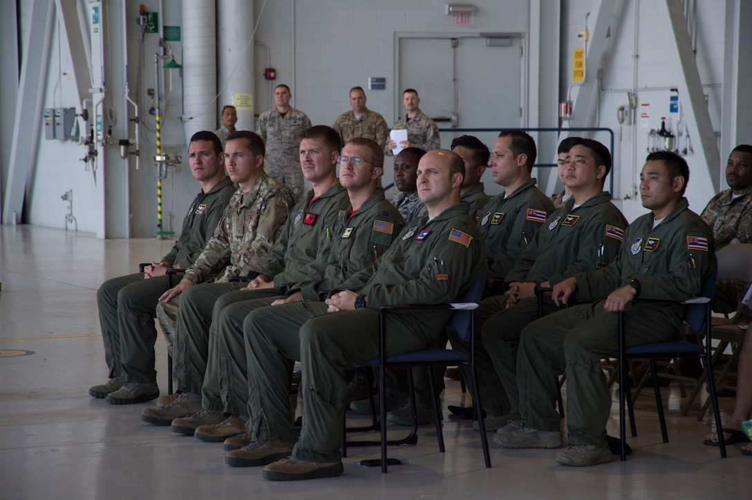 Aircrew members listen to Gen. Michael A. Minihan, U.S. Indo-Pacific Command chief of staff, during the North Korea Aircraft Commemorative Plaque Ceremony on Joint Base Pearl Harbor-Hickam, Hawaii, March 12, 2019. During the ceremony, aircrew members were recognized for their roles in the 2018 Honorable Carry mission that returned the remains of 55 American soldiers killed in the Korean War to the U.S. (U.S. Air Force photo by Tech. Sgt. Heather Redman)