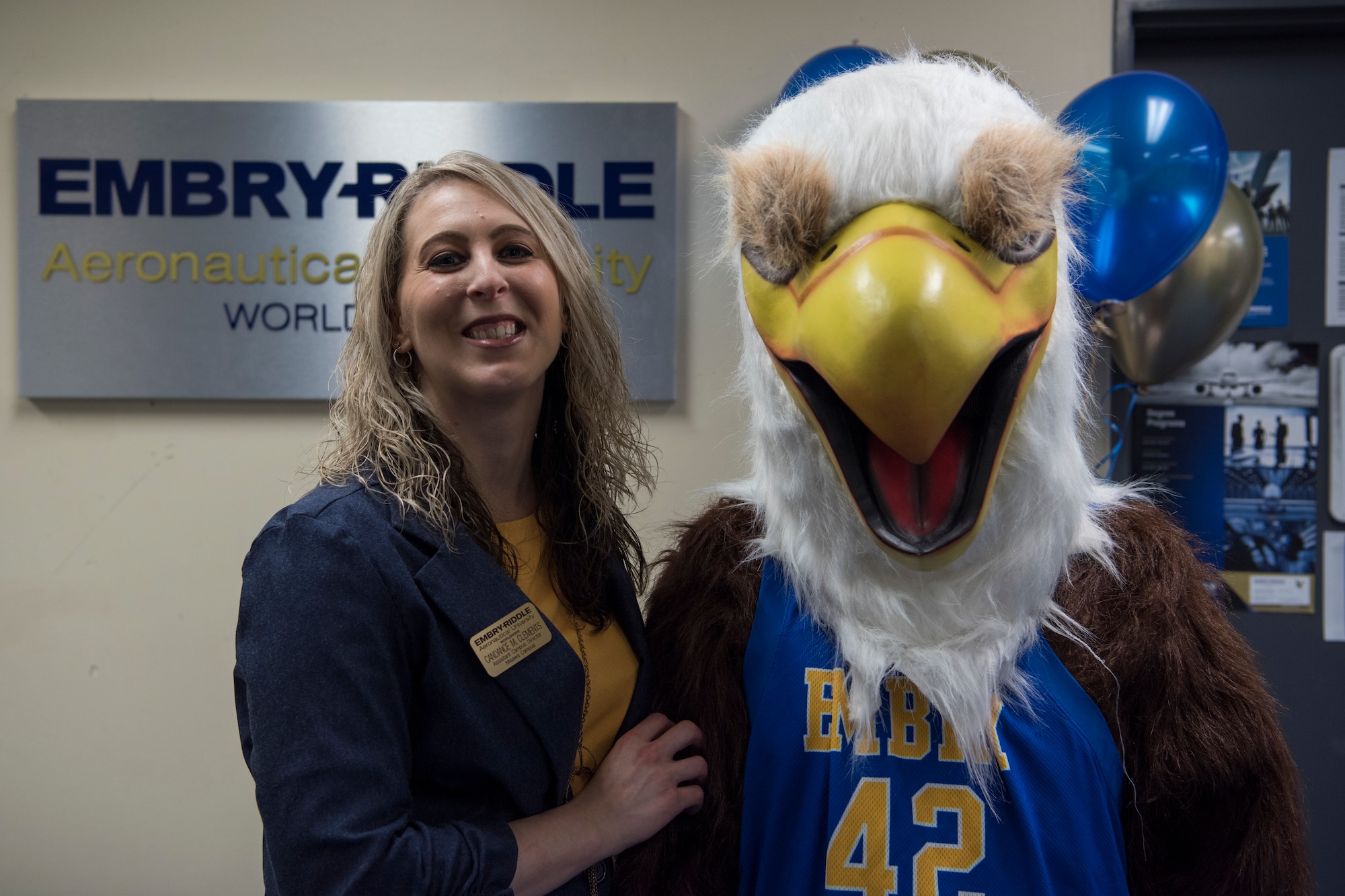 Candance Clements, left, the Misawa Embry-Riddle Aeronautical University assistant campus director, pauses for a photo during the ERAU grand re-opening with the school’s mascot, right, at Misawa Air Base, Japan, March 13, 2019. The institution offers nine-week courses focusing on aeronautics, aviation maintenance, aviation business administration, aviation security, unmanned systems applications and human factors. (U.S. Air Force photo by Airman 1st Class Collette Brooks)