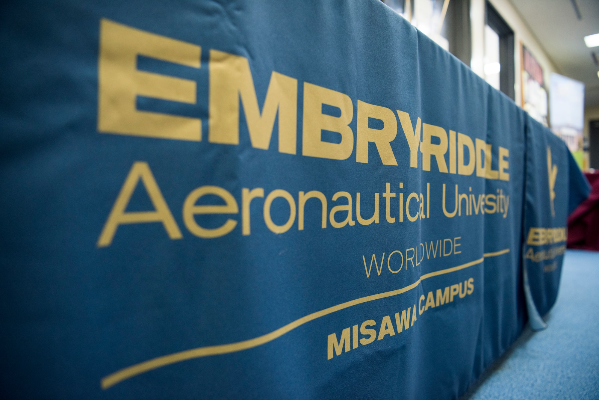An Embry-Riddle Aeronautical University banner hangs during the ERAU grand re-opening at Misawa Air Base, Japan, March 13, 2019. ERAU is an independent non-profit institution providing education in aviation, aerospace, engineering beneficial for aircraft and avionics wild weasel maintainers. (U.S. Air Force photo by Airman 1st Class Collette Brooks)