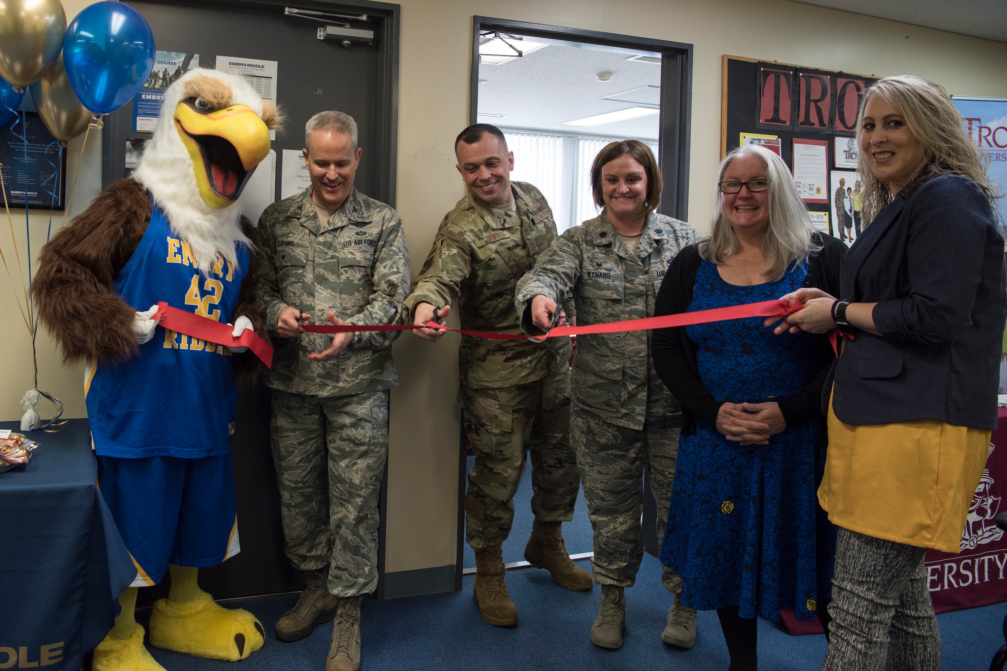 Embry-Riddle Aeronautical University grand re-opening attendees cut a ribbon to welcome the new university at Misawa Air Base, Japan, March 13, 2019. A temporary ERAU opened at MAB in 2017 measuring the interest of Team Misawa members. The Misawa education office opened a permanent school house after receiving an exceptional community response to the program. (U.S. Air Force photo by Airman 1st Class Collette Brooks)