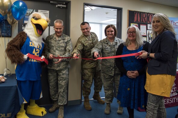 Embry-Riddle Aeronautical University grand re-opening attendees cut a ribbon to welcome the new university at Misawa Air Base, Japan, March 13, 2019. A temporary ERAU opened at MAB in 2017 measuring the interest of Team Misawa members. The Misawa education office opened a permanent school house after receiving an exceptional community response to the program. (U.S. Air Force photo by Airman 1st Class Collette Brooks)