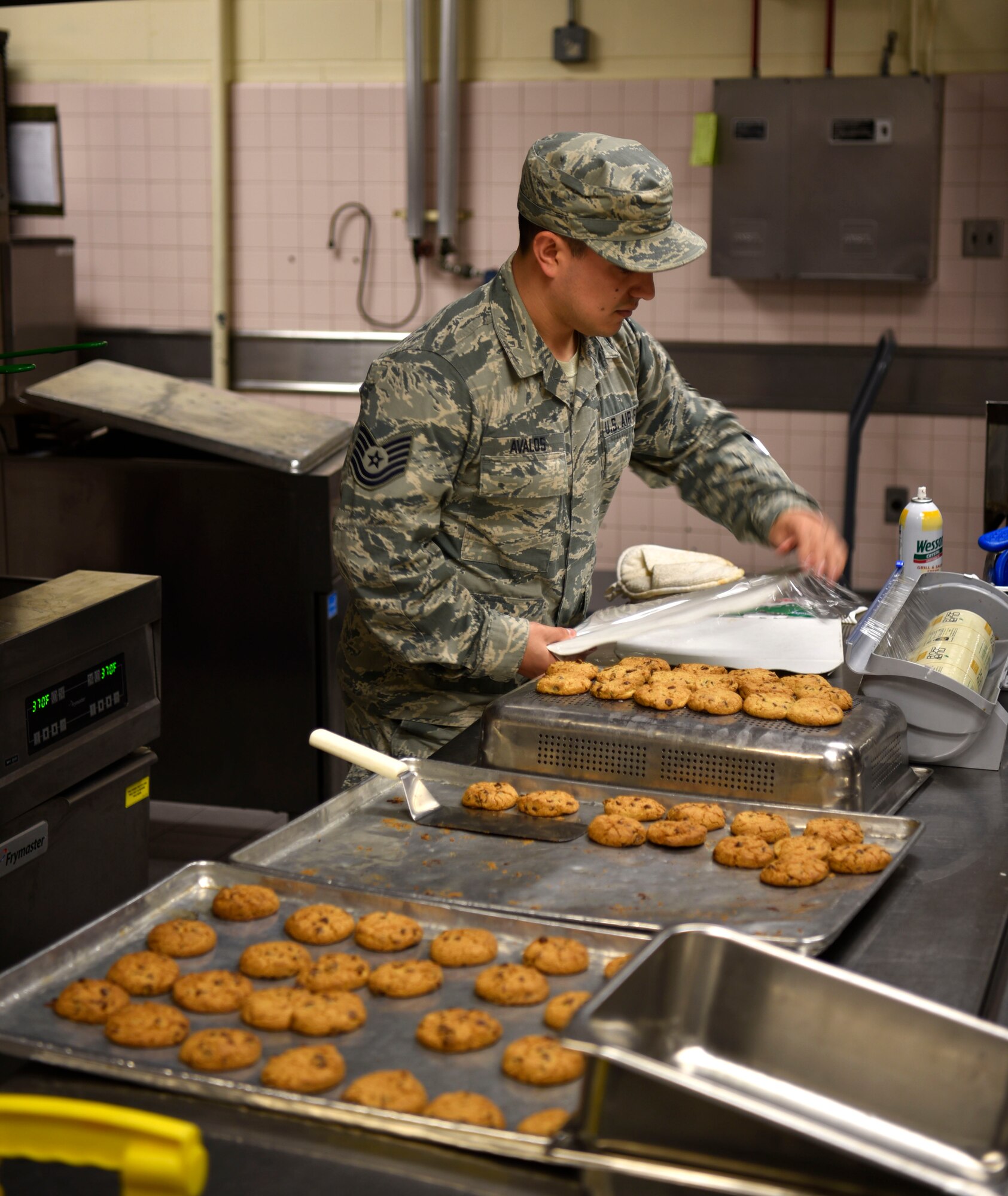 U.S. Air Force Tech. Sgt. Armando Avalos, 8th Force Support Squadron lodging noncommissioned officer in charge, wraps cookies during contingency meal service training at Kunsan Air Base, Republic of Korea, March 14, 2019. The meal service training keeps 8th FSS Airmen proficient in dining facility operations during a contingency event and provides a valuable opportunity for Airmen to practice food preparation usually performed by government contractors. (U.S. Air Force photo by Tech. Sgt. Charles McNamara)