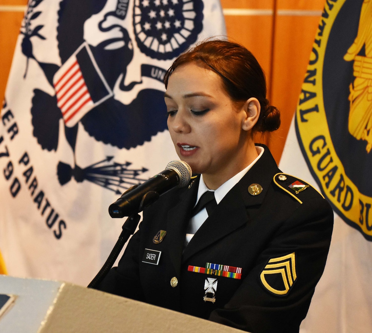 New York Army National Guard Soldier Staff Sgt. Norma Saderi, Joint Task Force-Empire Shield, translates from English to Portuguese for a state partnership signing, on the USS Intrepid, Manhattan, New York, March 14, 2019.