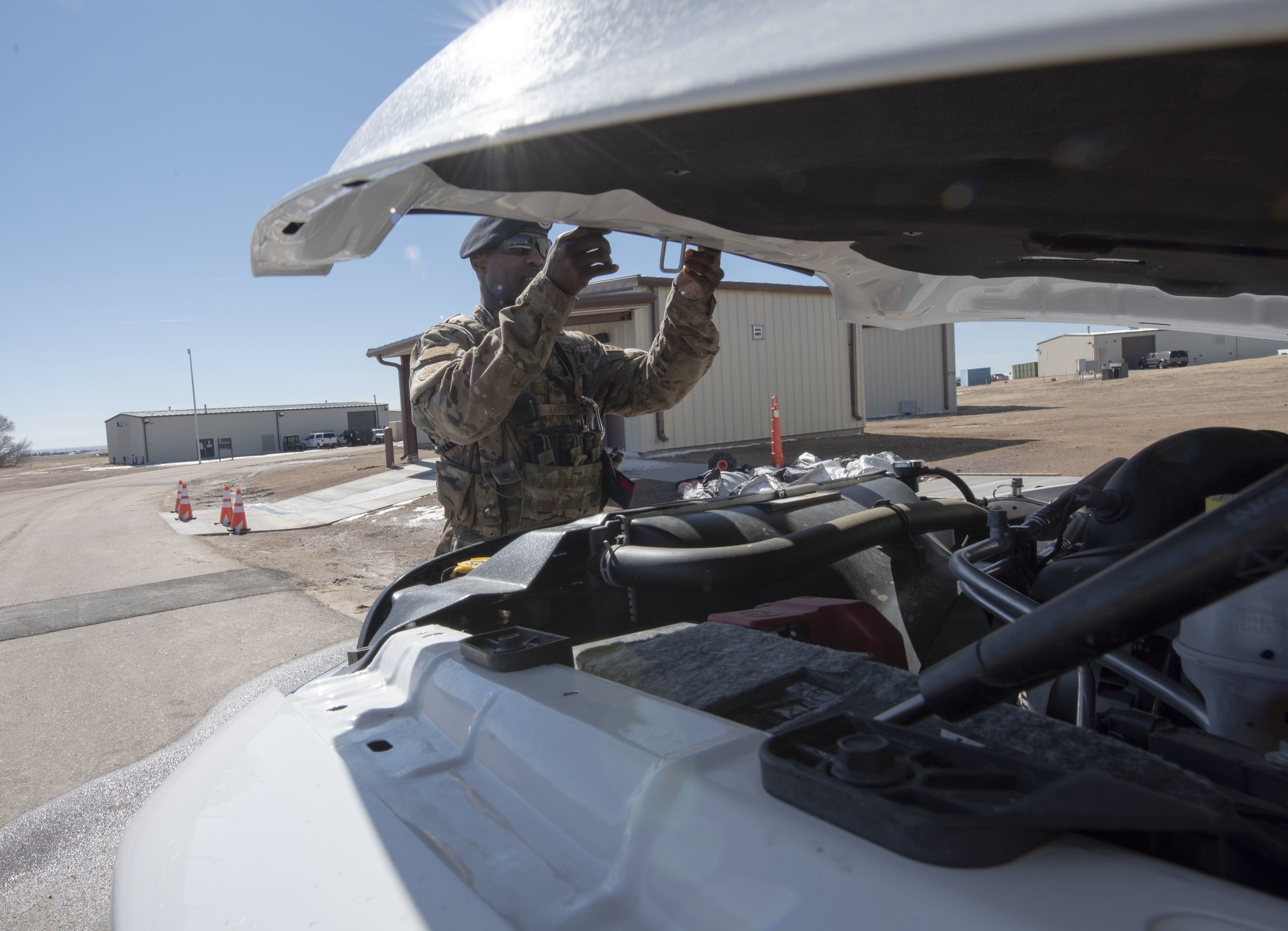 Tech. Sgt.  Jerald Harris, 50th Security Forces Squadron flight chief, checks under the hood of a vehicle during a training session at the 50th SFS training facility at Schriever Air Force Base, Colorado, March 16, 2019. The 50th SFS training flight conducts 216 hours of training are conducted annually for the base’s defenders.  (U.S. Air Force photo by Staff Sgt. Matthew Coleman-Foster)