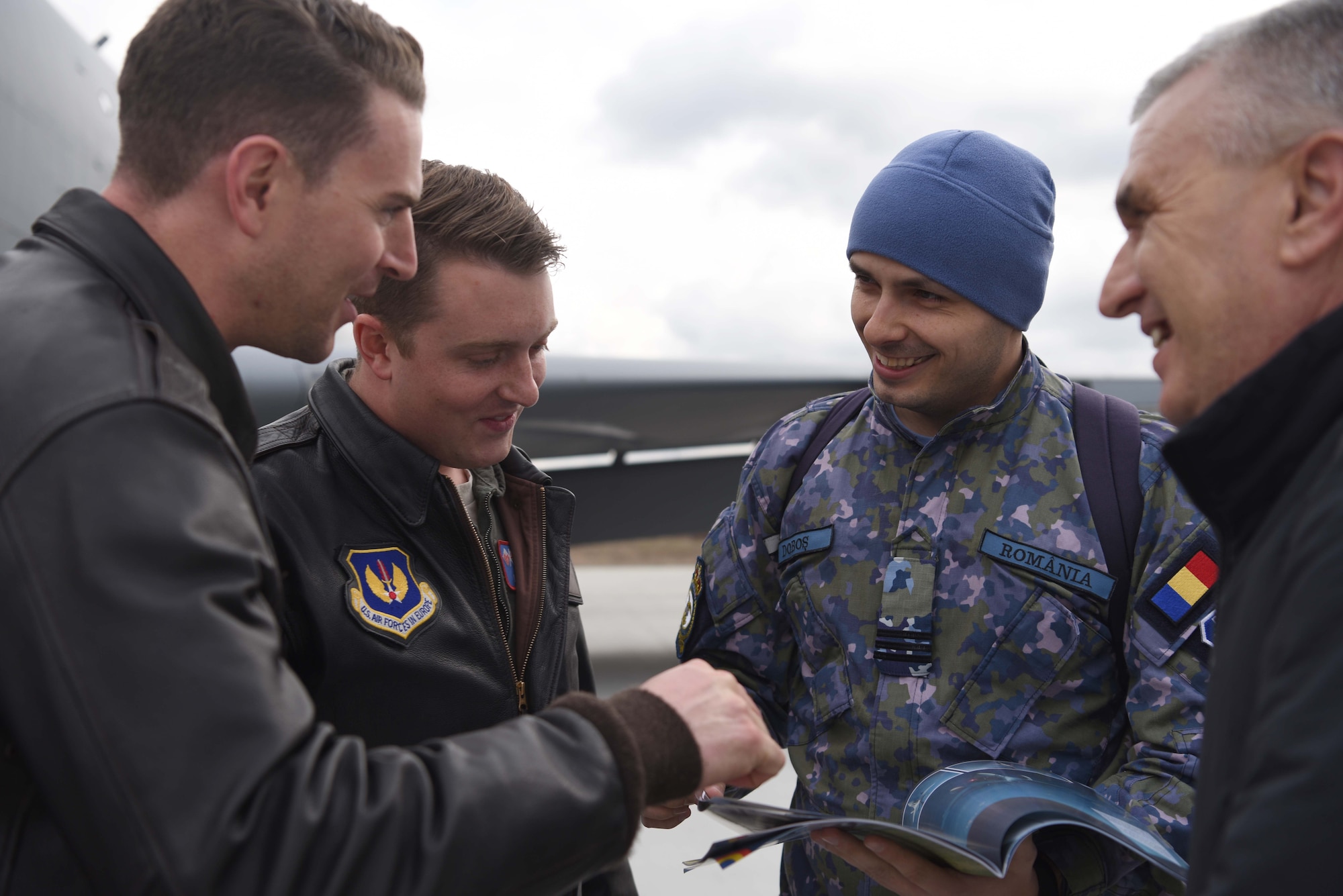 U.S. Airmen and Romanian air force members discuss aerial refueling events after training with Romanian air force F-16s in Bucharest, Romania, March 12, 2019. The crew trained with Romanian air force F-16s over the skies of Romania, which enhanced regional capabilities to secure air sovereignty and promote peace and security through cooperation, collaboration, interoperability with NATO allies in the region. (U.S. Air Force photo by Airman 1st Class Brandon Esau)