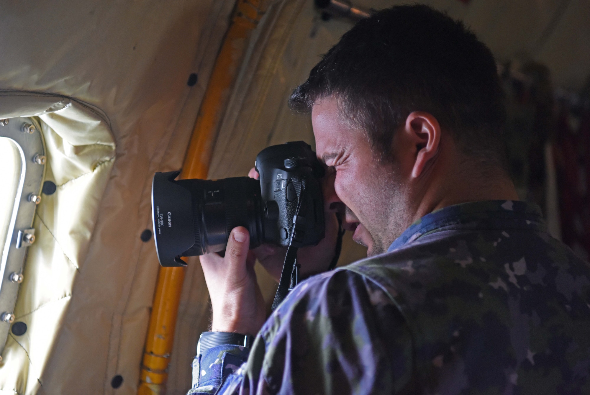 Romanian air force Warrant Officer Bogdan Pantilimon takes photos during aerial refueling training with Romanian F-16s over the skies of Romania, March 12, 2019. The training was an example of U.S. and NATO allies sharing a commitment to promote peace and stability through developing their relationship and communication process. (U.S. Air Force photo by Airman 1st Class Brandon Esau)