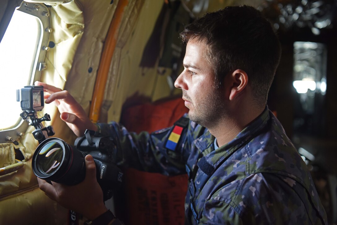 Romanian air force Warrant Officer Bogdan Pantilimon records refueling of Romanian air force F-16s aboard a 100th Air Refueling Wing KC-135 Stratotanker from RAF Mildenhall, England, March 12, 2019. The crew trained with Romanian air force F-16s over the skies of Romania, which enhanced regional capabilities to secure air sovereignty and promote peace and security through cooperation, collaboration, interoperability with NATO allies in the region. (U.S. Air Force photo by Airman 1st Class Brandon Esau)