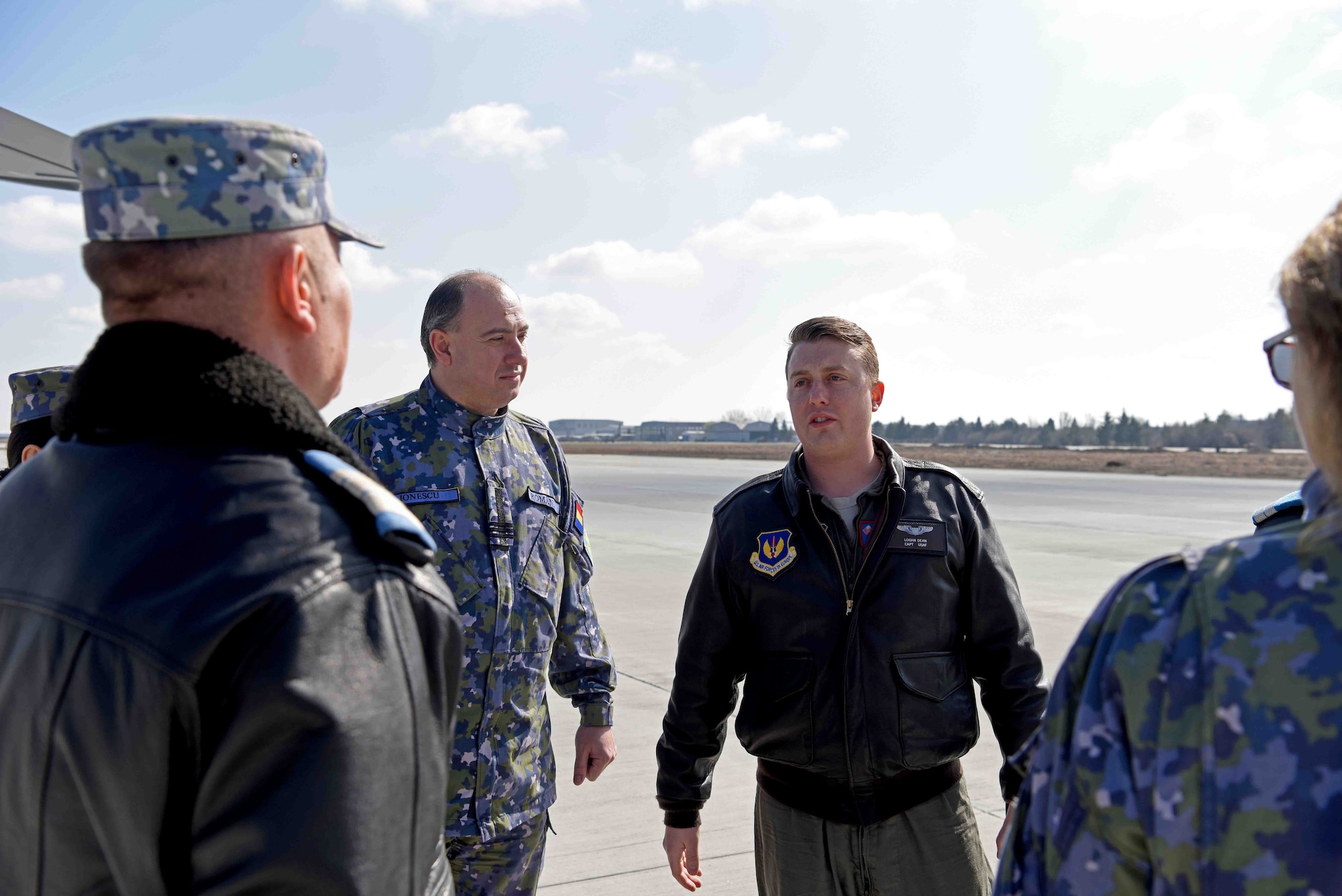 U.S. Air Force Capt. Logan Dean, 351st Air Refueling Squadron pilot, discusses aerial refueling events with Romanian air force members prior to take-off for training with Romanian air force F-16s in Bucharest, Romania, March 13, 2019. The training was an example of U.S. and NATO allies sharing a commitment to promote peace and stability through developing their relationship and communication process. (U.S. Air Force photo by Airman 1st Class Brandon Esau)