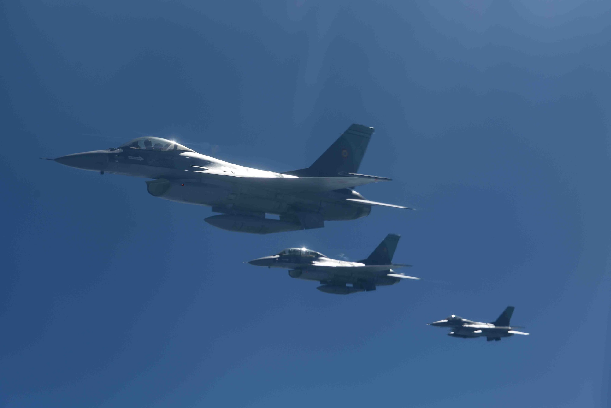 Romanian air force F-16s fly in formation after receiving fuel from a 100th Air Refueling Wing KC-135 Stratotanker from RAF Mildenhall, England, during training over the skies of Romania, March 13, 2019. The training was an example of U.S. and NATO allies sharing a commitment to promote peace and stability through developing their relationship and communication process. (U.S. Air Force photo by Airman 1st Class Brandon Esau)