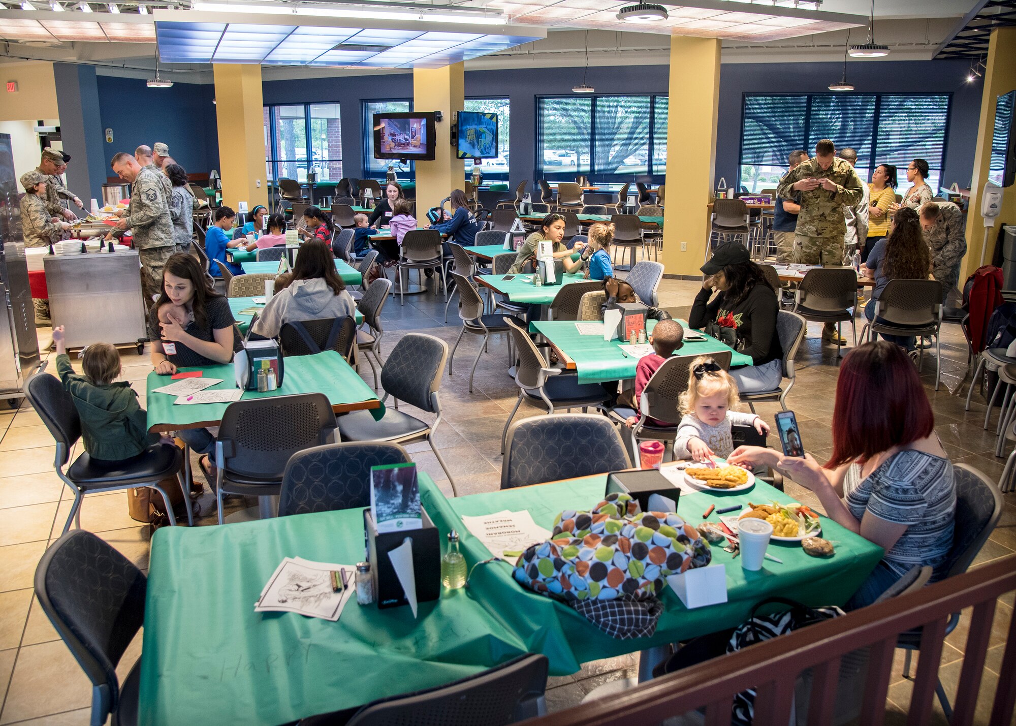 Participants eat and socialize during a deployed spouses dinner, March 19, 2019, at Moody Air Force Base, Ga. The mission’s success depends on resilient Airmen and families, who are prepared to make sacrifices with the support of their fellow Airmen, local communities and leadership. (U.S. Air Force photo by Airman 1st Class Eugene Oliver)