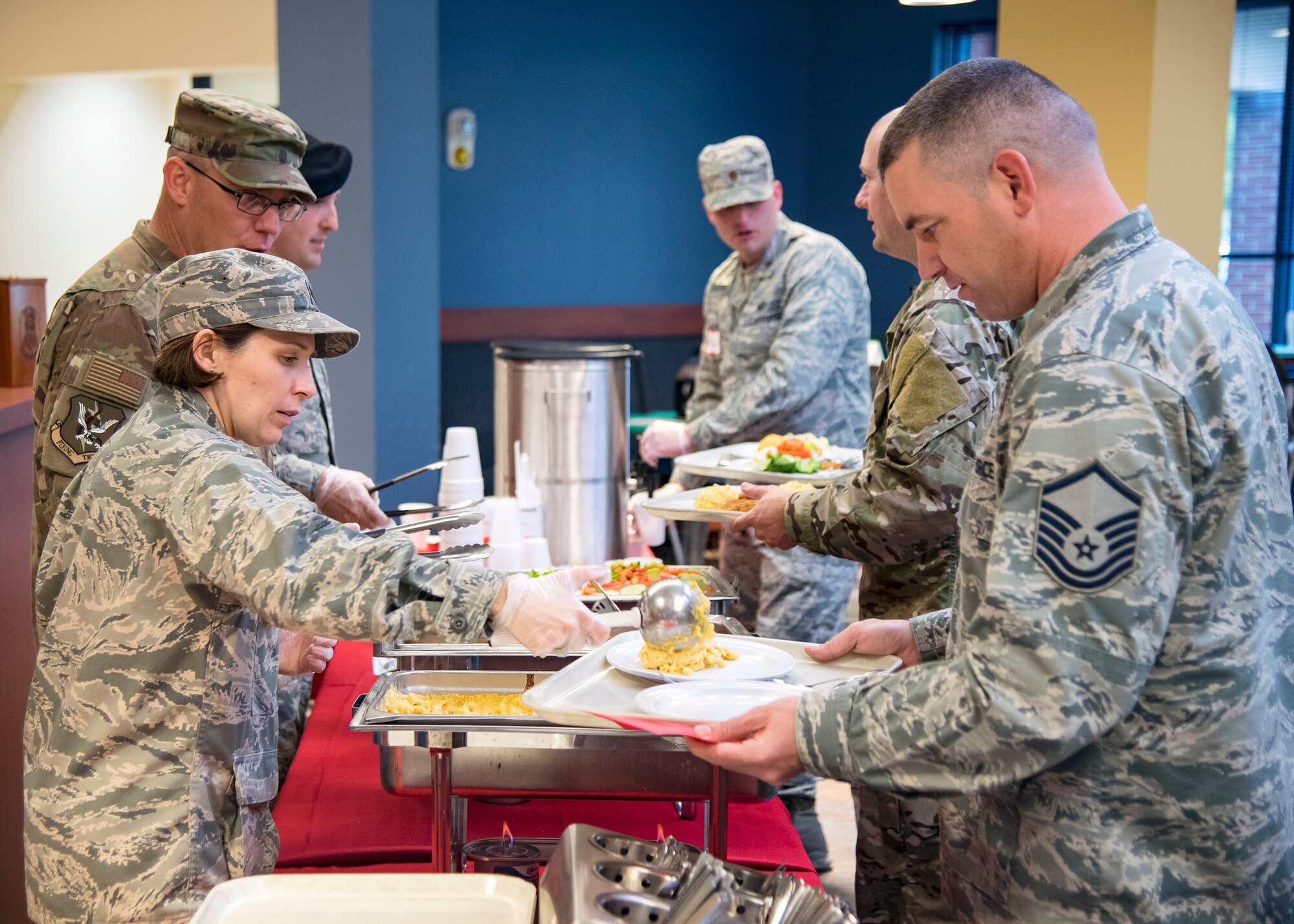 Moody Leadership serves food during a deployed spouses dinner, March 19, 2019, at Moody Air Force Base, Ga. The mission’s success depends on resilient Airmen and families, who are prepared to make sacrifices with the support of their fellow Airmen, local communities and leadership. (U.S. Air Force photo by Airman 1st Class Eugene Oliver)