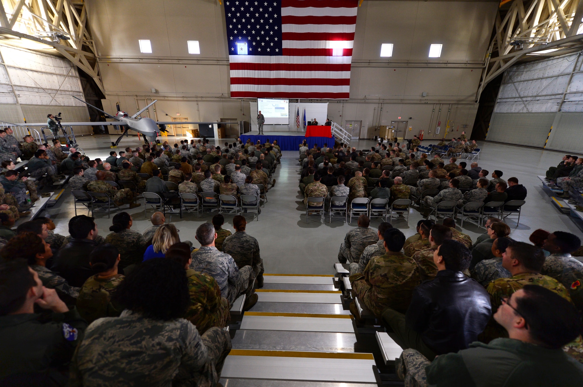 Chief Master Sgt. Jamie Newman, 432nd Wing/432nd Air Expeditionary Wing command chief, discusses lethality and readiness of the Remotely Piloted Aircraft enterprise during an all-call at Creech Air Force Base, Nevada, Mar. 8, 2019. Newman and Col. Julian Cheater, 432nd WG/432nd AEW commander, reviewed the progress the wing has made in the past two years and gave Airmen a preview of what the plans for the next two are. (U.S. Air Force photo by Tech. Sgt. Dillon White)