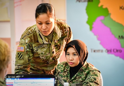 U.S. Army Lt. Col. Angela Gentry, Washington Army National Guard, discusses battle drills with her Malaysian army counterpart, Maj. Nurkhairunisa, during Exercise Bersama Warrior in Malaysia, March 10, 2019.