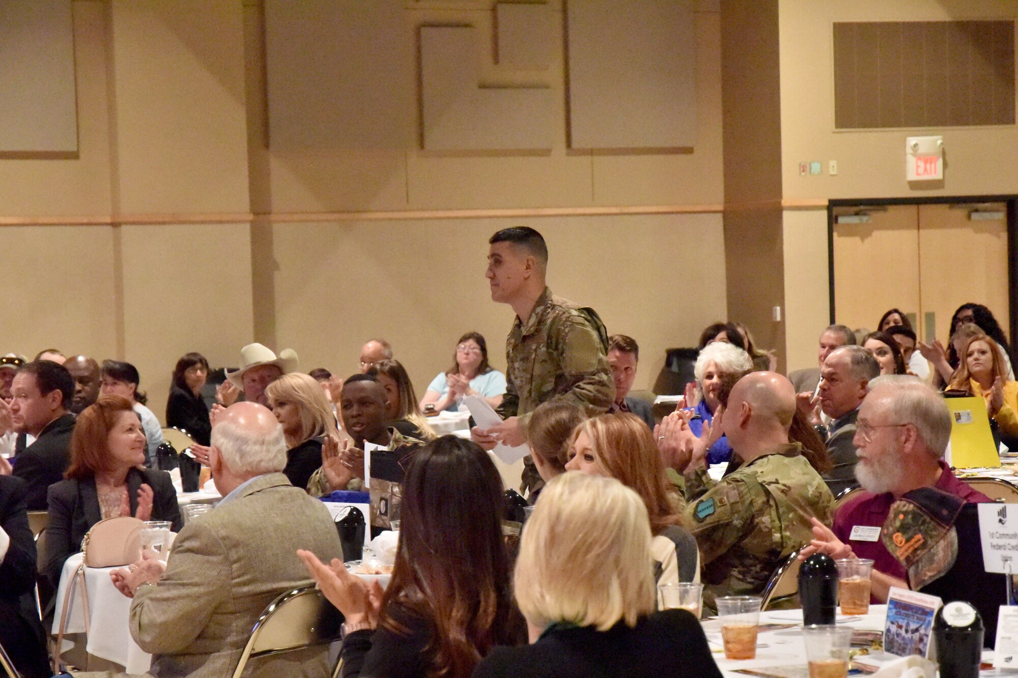 U.S. Air Force Col. Ricky Mills, 17th Training Wing commander, rises to give an update on Goodfellow Air Force Base at the Chamber of Commerce Membership Luncheon at the McNease Convention Center in San Angelo, Texas, March 19, 2019. Mills spoke about the base's accomplishments thanks to the support of the community of San Angelo. (U.S. Air Force photo by 2nd Lt. Matthew Stott/Released)