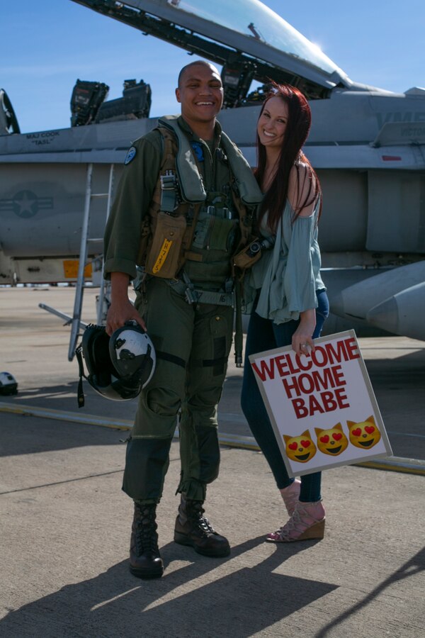 U.S. Marine Corps Capt. Nicholas Hancock, an F/A-18 weapons systems officer with Marine Fighter Attack Squadron 225, Marine Aircraft Group 11, 3rd Marine Aircraft Wing, poses with a loved one at Marine Corps Air Station Miramar, Calif., March 15, following a six-month Unit Deployment Program in Japan. Marines and Sailors flew, fixed, and fought alongside foreign forces throughout Guam, South Korea, and Japan as part of America’s Expeditionary Force in Readiness. (U.S. Marine Corps photo by Lance Cpl. Julian Elliott-Drouin)