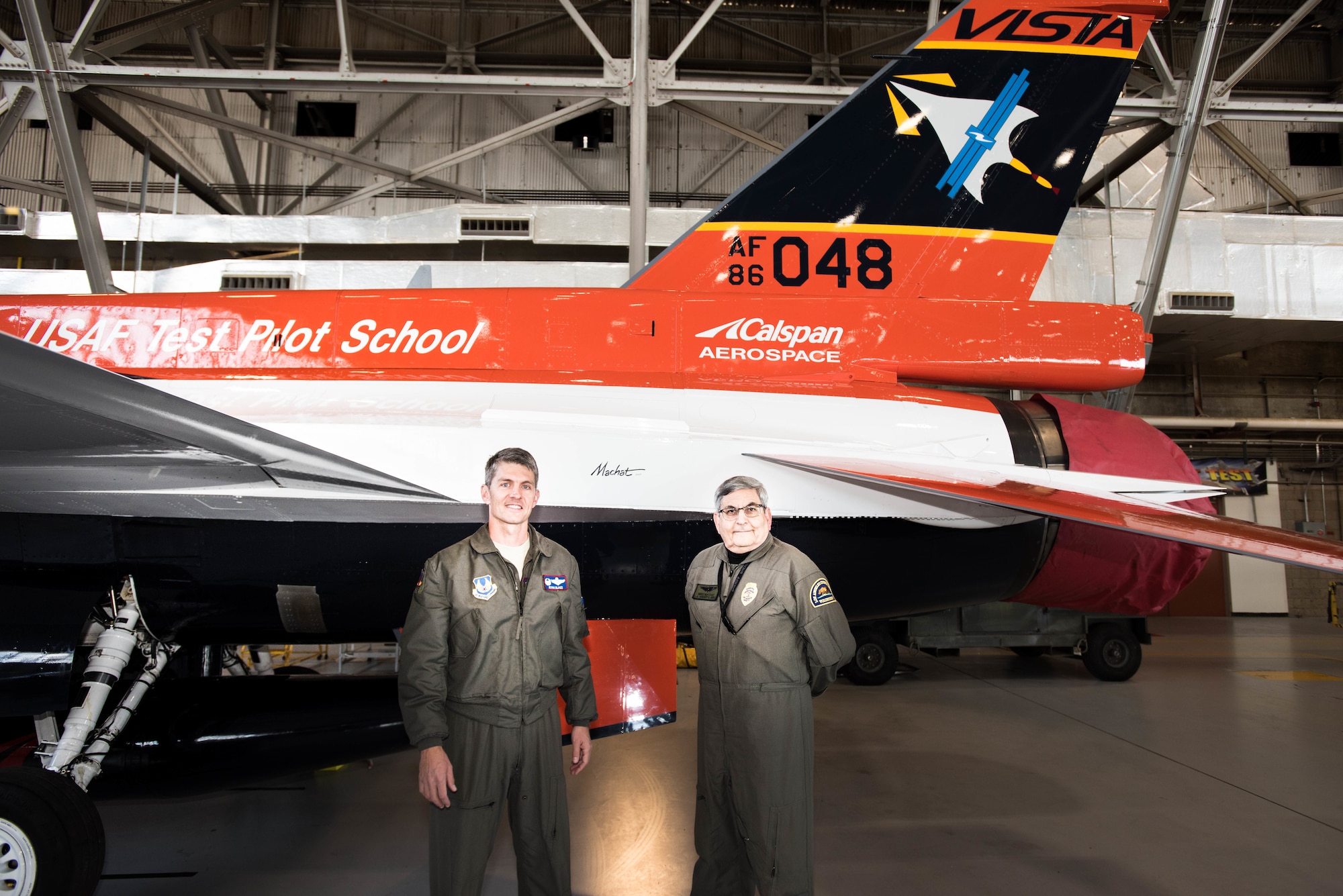 Col. Ryan Blake, U.S. Air Force Test Pilot School commandant (left), poses for a photo with aviation artist Mike Machat in front of the school’s NF-16D VISTA in-flight simulator March 7. The VISTA is sporting a new paint scheme designed by Machat. 
 (U.S. Air Force photo by Joe Jones)