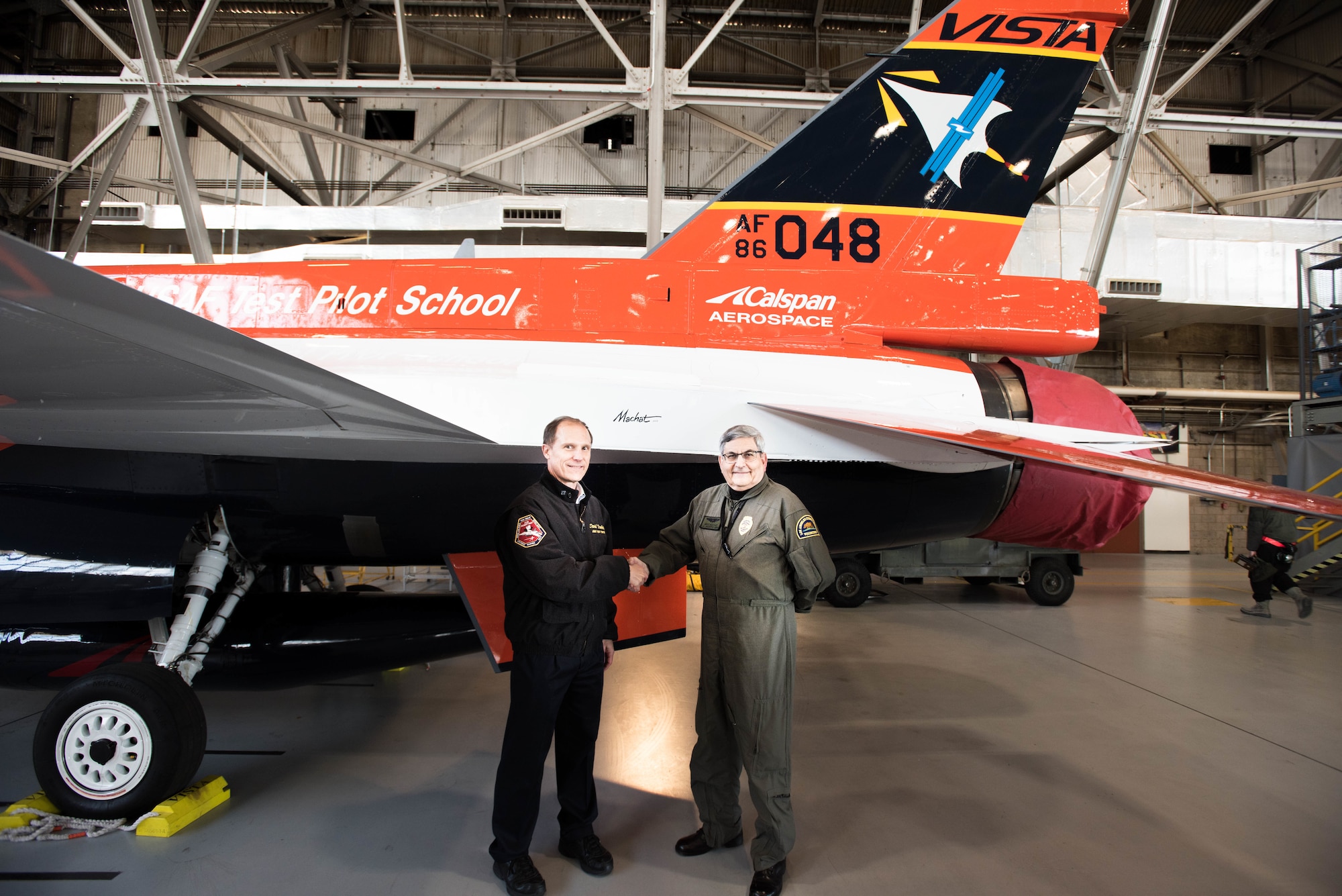 Col. Ryan Blake, U.S. Air Force Test Pilot School commandant (left), poses for a photo with aviation artist Mike Machat in front of the school’s NF-16D VISTA in-flight simulator March 7. The VISTA is sporting a new paint scheme designed by Machat. 
 (U.S. Air Force photo by Joe Jones)