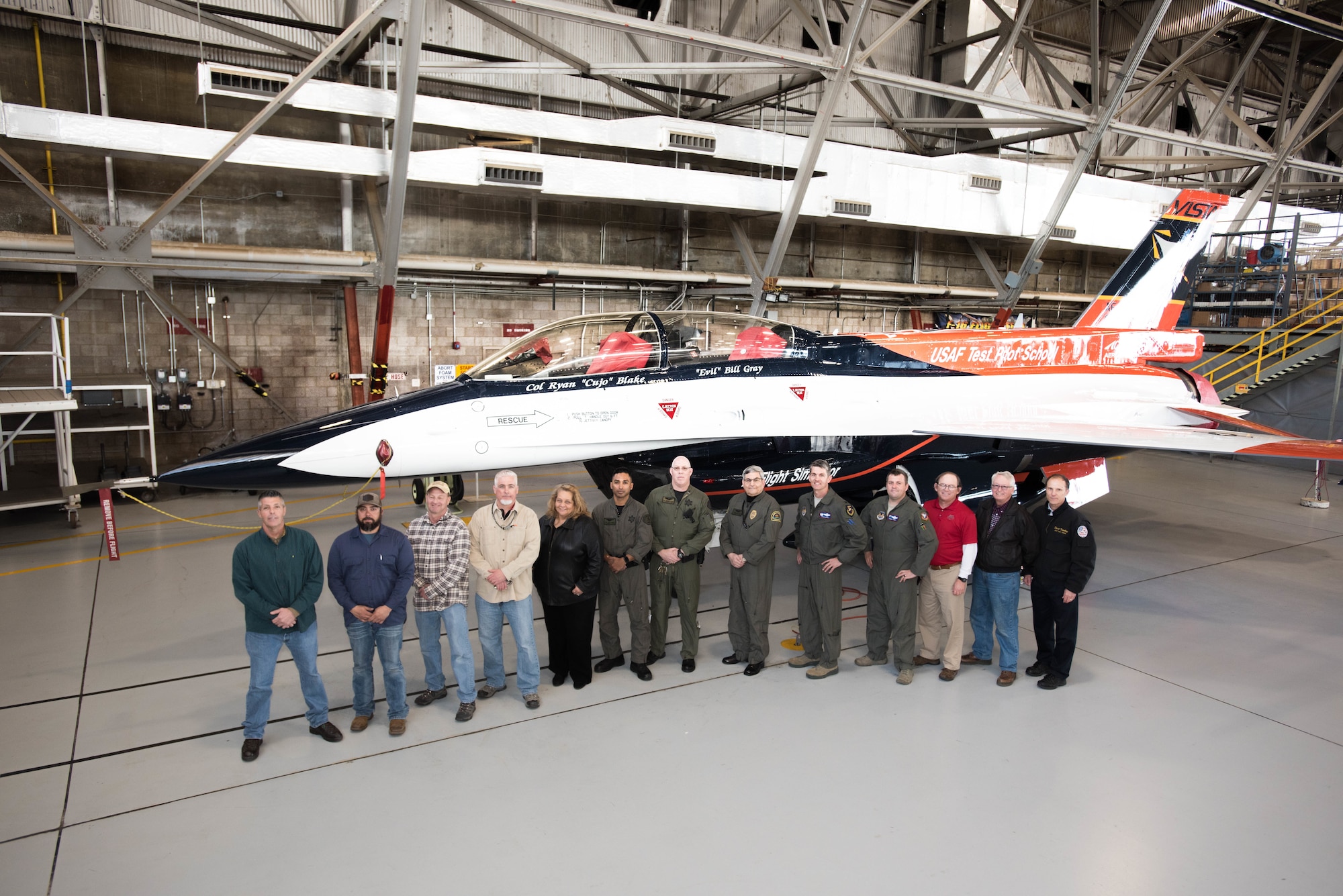 Members of the U.S. Air Force Test Pilot School and aircraft maintainers pose for a photo in front of the school’s NF-16D VISTA in-flight simulator The VISTA is sporting a new paint scheme designed by aviation artist Mike Machat. The one-of-a-kind aircraft is a staple of the school. VISTA is an acronym that stands for Variable stability In-flight Simulator Test Aircraft. The modified F-16 can be configured to fly like almost any aircraft type. (U.S. Air Force photo by Joe Jones)