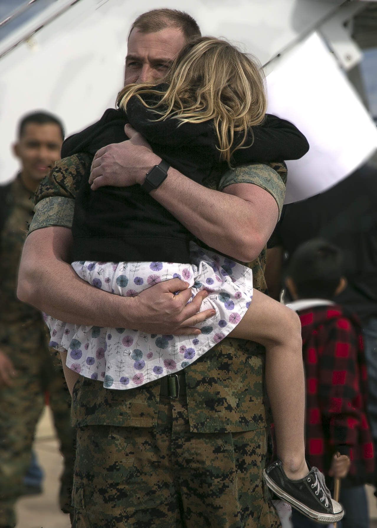 U.S. Marine Corps Gunnery Sgt. Benjamin Shangraw, an aircraft airframe mechanic with Marine Fighter Attack Squadron (All-Weather) [VMFA(AW)] 225, Marine Aircraft Group (MAG) 11, 3rd Marine Aircraft Wing, embraces his daughter at Marine Corps Air Station Miramar, Calif., March 10, following a six-month Unit Deployment Program (UDP) in Japan. Marines and Sailors trained alongside foreign forces throughout Guam, South Korea, and Japan as part of America's Expeditionary Force in Readiness. (U.S. Marine Corps photo by Lance Cpl. Julian Elliott-Drouin)