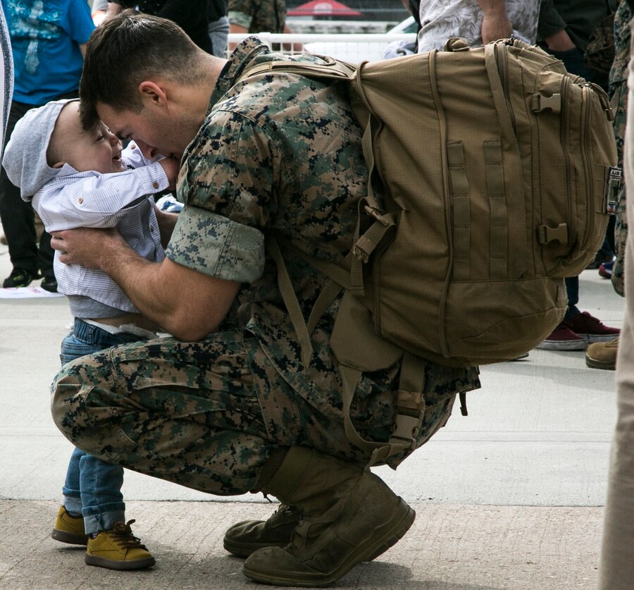 U.S. Marine Corps Sgt.Samuel Mullins, an aircraft electrical systems technician with Marine Fighter Attack Squadron (All-Weather) [VMFA(AW)] 225, Marine Aircraft Group (MAG) 11, 3rd Marine Aircraft Wing, reunites with his son at Marine Corps Air Station Miramar, Calif., March 10, following a six-month Unit Deployment Program (UDP) in Japan. Marines and Sailors trained alongside foreign forces throughout Guam, South Korea, and Japan as part of America's Expeditionary Force in Readiness. (U.S. Marine Corps photo by Lance Cpl. Julian Elliott-Drouin)