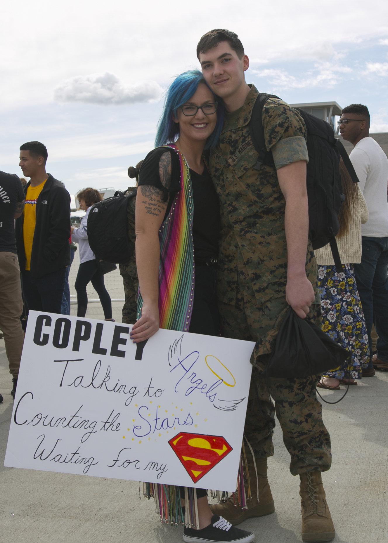 U.S. Marine Corps Cpl. Jonathon Copely, an aviation ordnance equipment repair technician with Marine Fighter Attack Squadron (All-Weather) [VMFA(AW)] 225, Marine Aircraft Group (MAG) 11, 3rd Marine Aircraft Wing, poses with a loved one at Marine Corps Air Station Miramar, Calif., March 10, following a six-month Unit Deployment Program (UDP) in Japan. Marines and Sailors trained alongside foreign forces throughout Guam, South Korea, and Japan as part of America's Expeditionary Force in Readiness. (U.S. Marine Corps photo by Lance Cpl. Julian Elliott-Drouin)