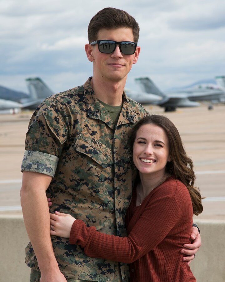 U.S. Marine Corps Cpl. Devin Smith, an aviation ordnance repair technician with Marine Fighter Attack Squadron (All-Weather) [VMFA(AW)] 225, Marine Aircraft Group (MAG) 11, 3rd Marine Aircraft Wing, poses with a loved one at Marine Corps Air Station Miramar, Calif., March 10, following a six-month Unit Deployment Program (UDP) in Japan. Marines and Sailors trained alongside foreign forces throughout Guam, South Korea, and Japan as part of America's Expeditionary Force in Readiness. (U.S. Marine Corps photo by Lance Cpl. Julian Elliott-Drouin)