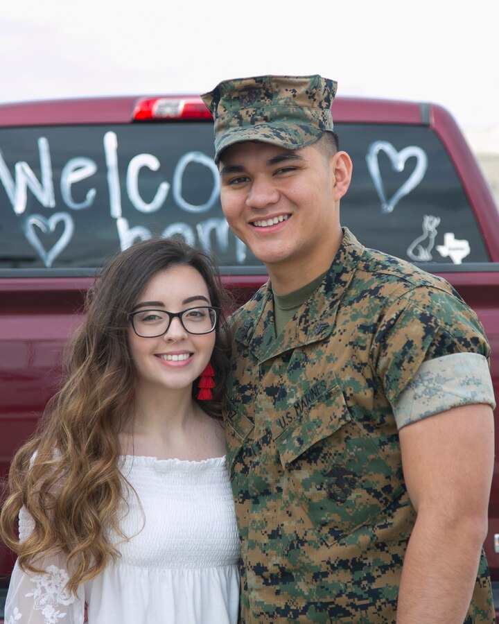 U.S. Marine Corps Cpl. Alessandro Lopez, an aircraft electrical systems technician with Marine Fighter Attack Squadron (All-Weather) [VMFA(AW)] 225, Marine Aircraft Group (MAG) 11, 3rd Marine Aircraft Wing, poses with a loved one at Marine Corps Air Station Miramar, Calif., March 10, following a six-month Unit Deployment Program (UDP) in Japan. Marines and Sailors trained alongside foreign forces throughout Guam, South Korea, and Japan as part of America's Expeditionary Force in Readiness. (U.S. Marine Corps photo by Lance Cpl. Julian Elliott-Drouin)
